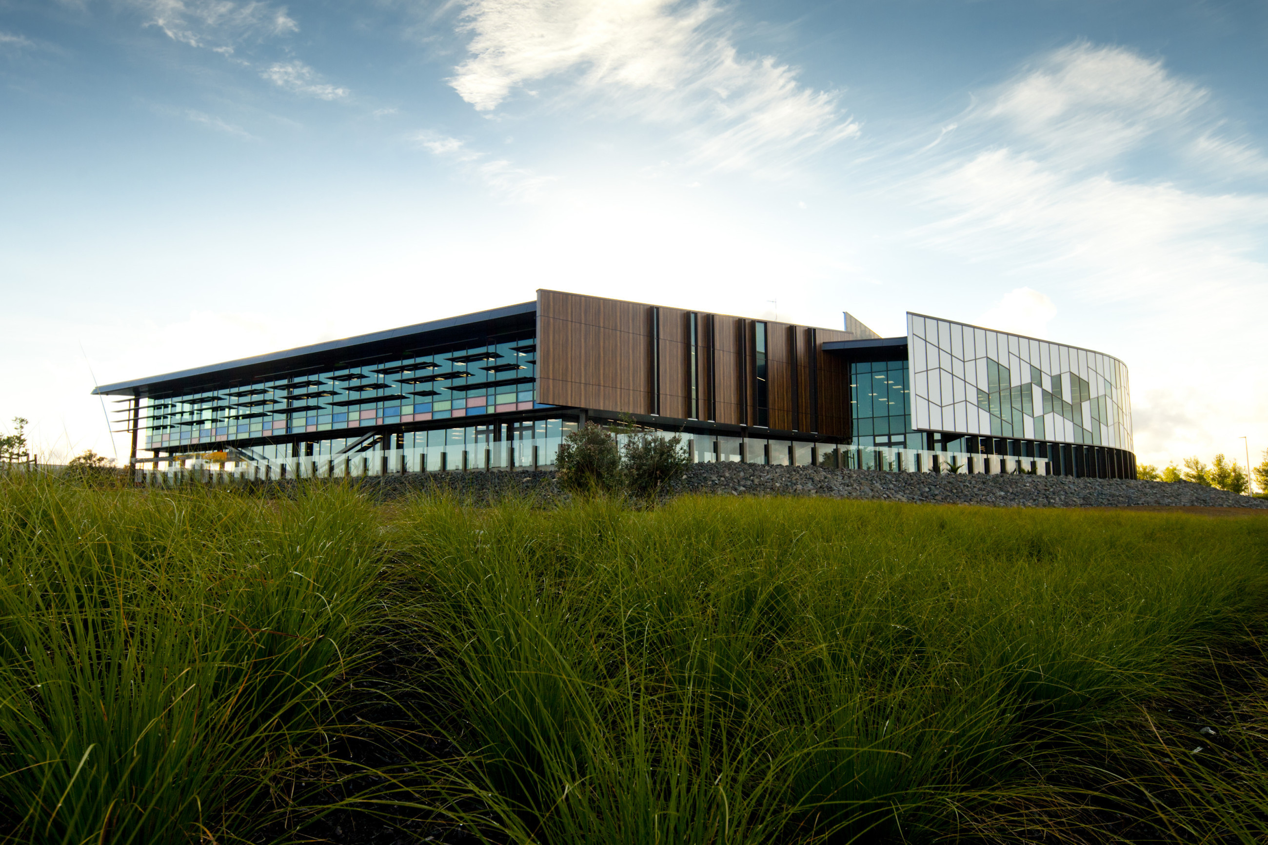 Urban structure with a unique design element and glass overhangs and timber