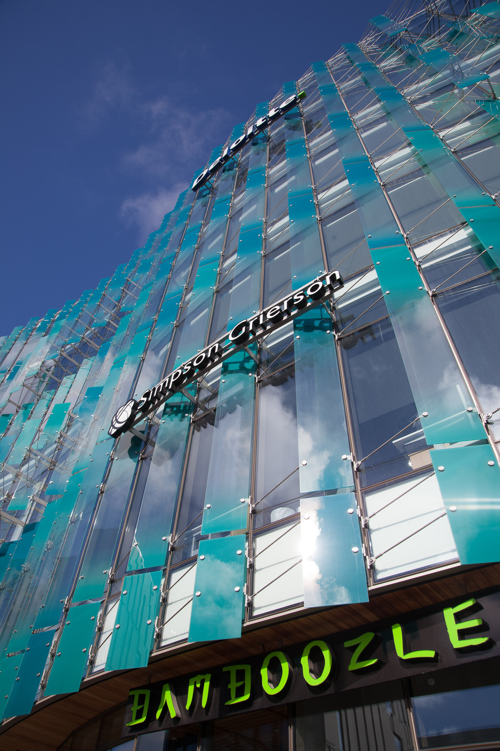 Contemporary building with a bold triangular motif and translucent glass canopies