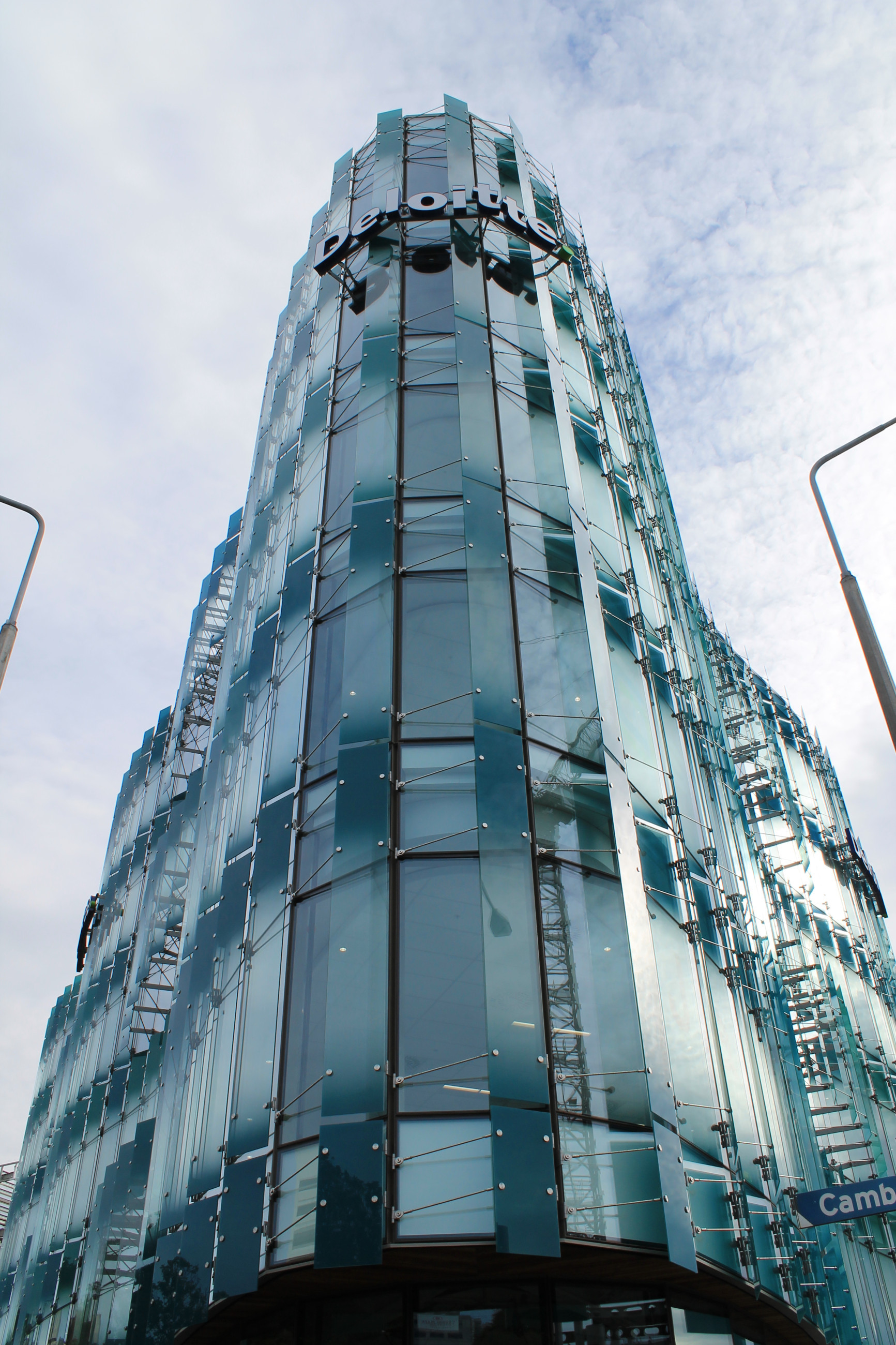 Modern tower with a geometric triangle design and protective glass canopies