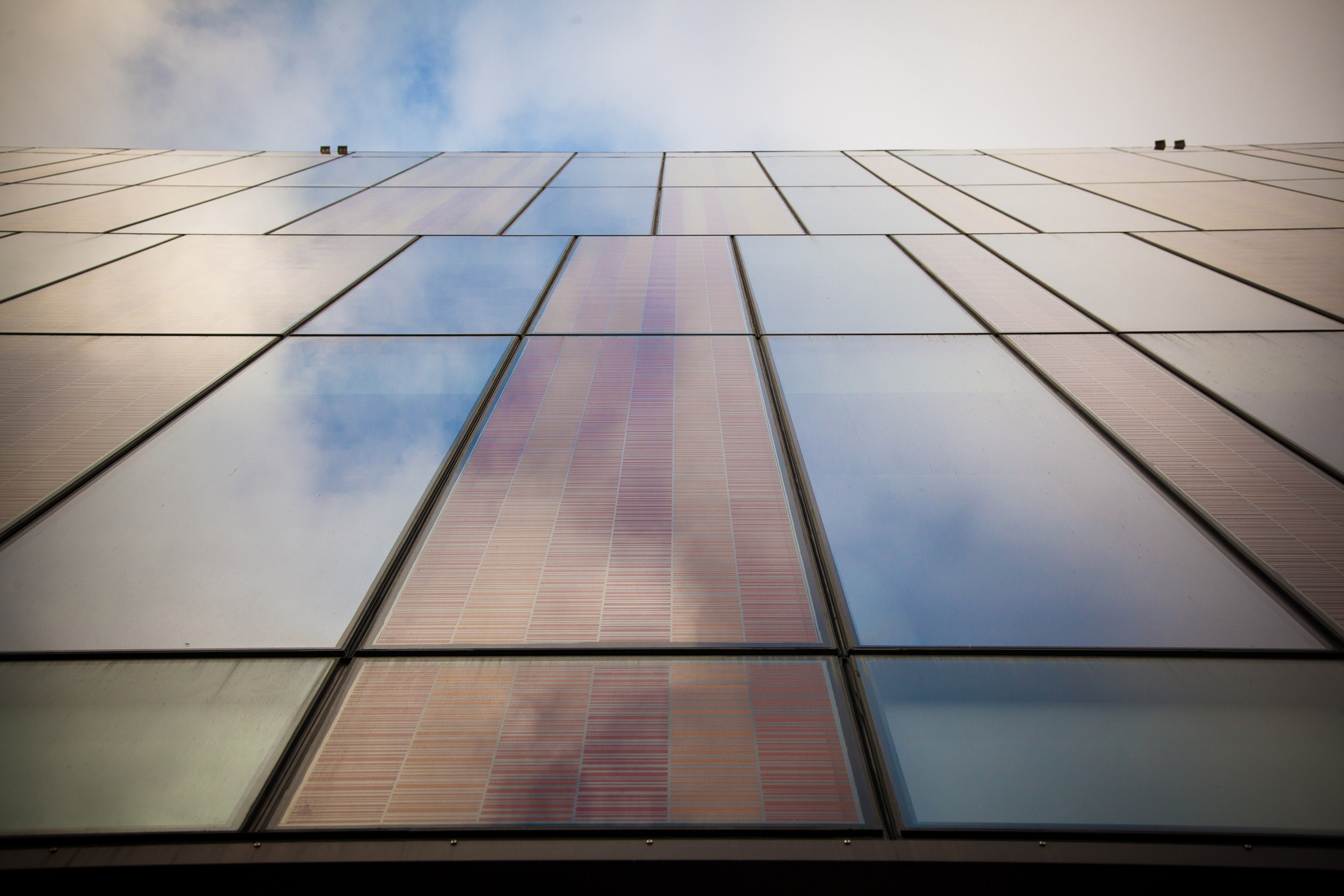 Architectural design featuring a glass canopy and eye-catching wooden patterns