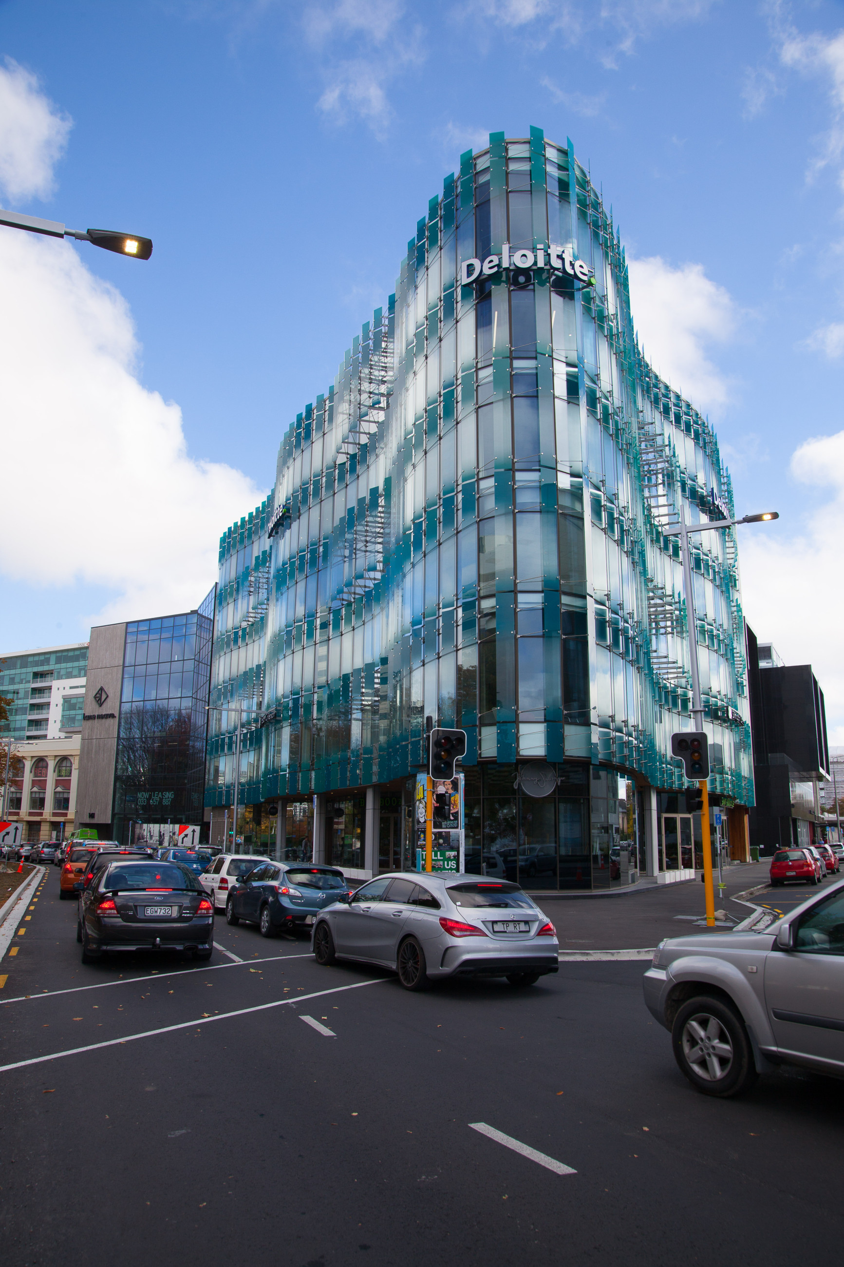 High-rise featuring a triangular architectural detail and elegant glass canopies