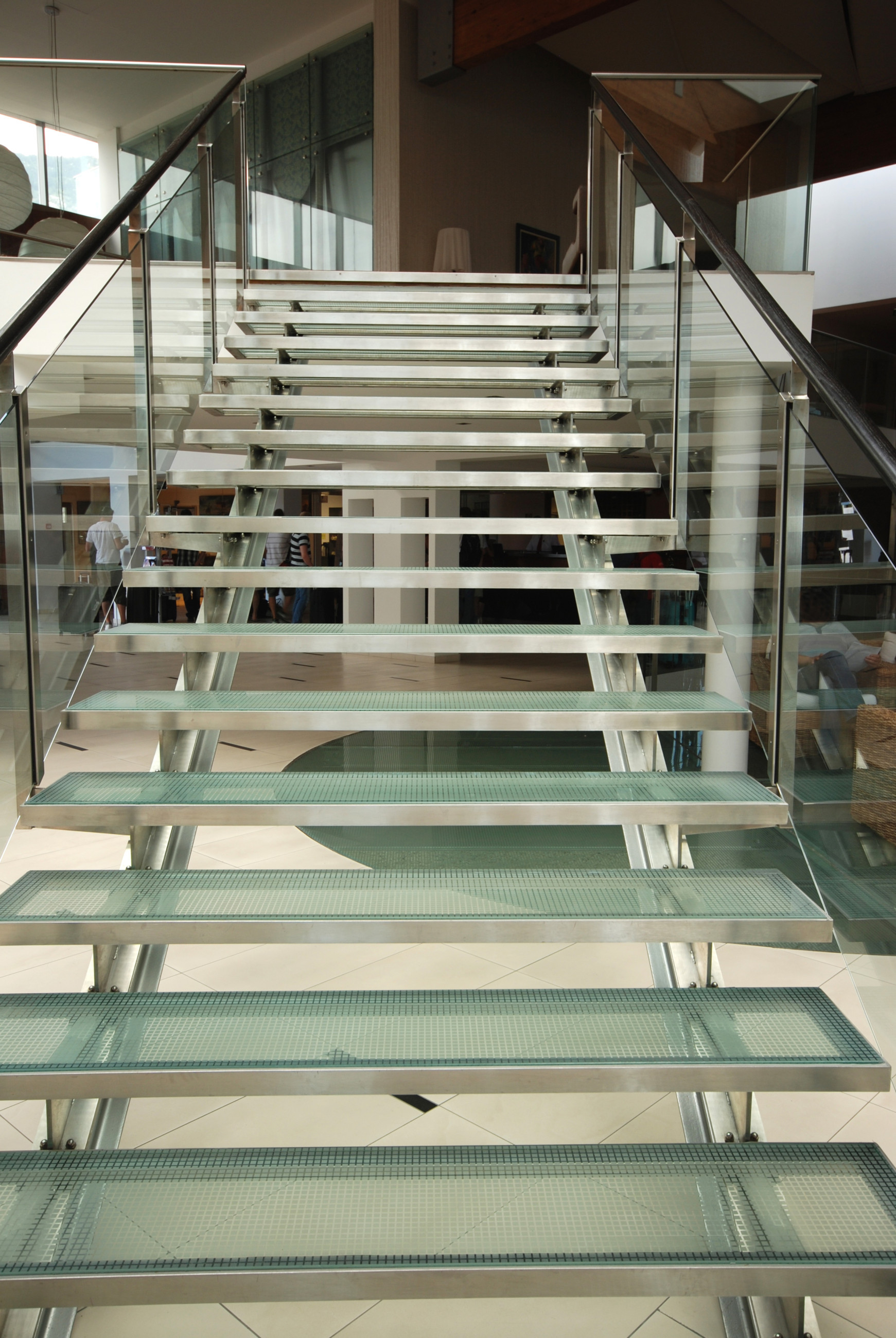 Patterned glass stairs with white floor
