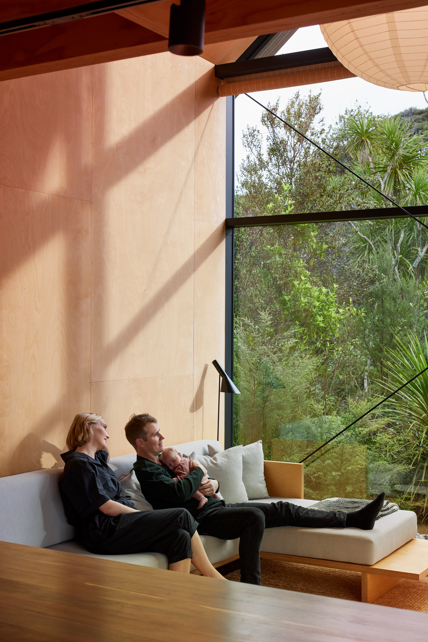 Naturalistic design in a home interior with a seamless glass corner window showcasing a bush vista