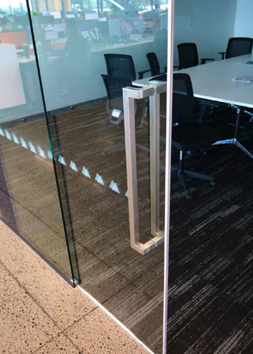 Sleek glass doors opening to a modern commercial interior