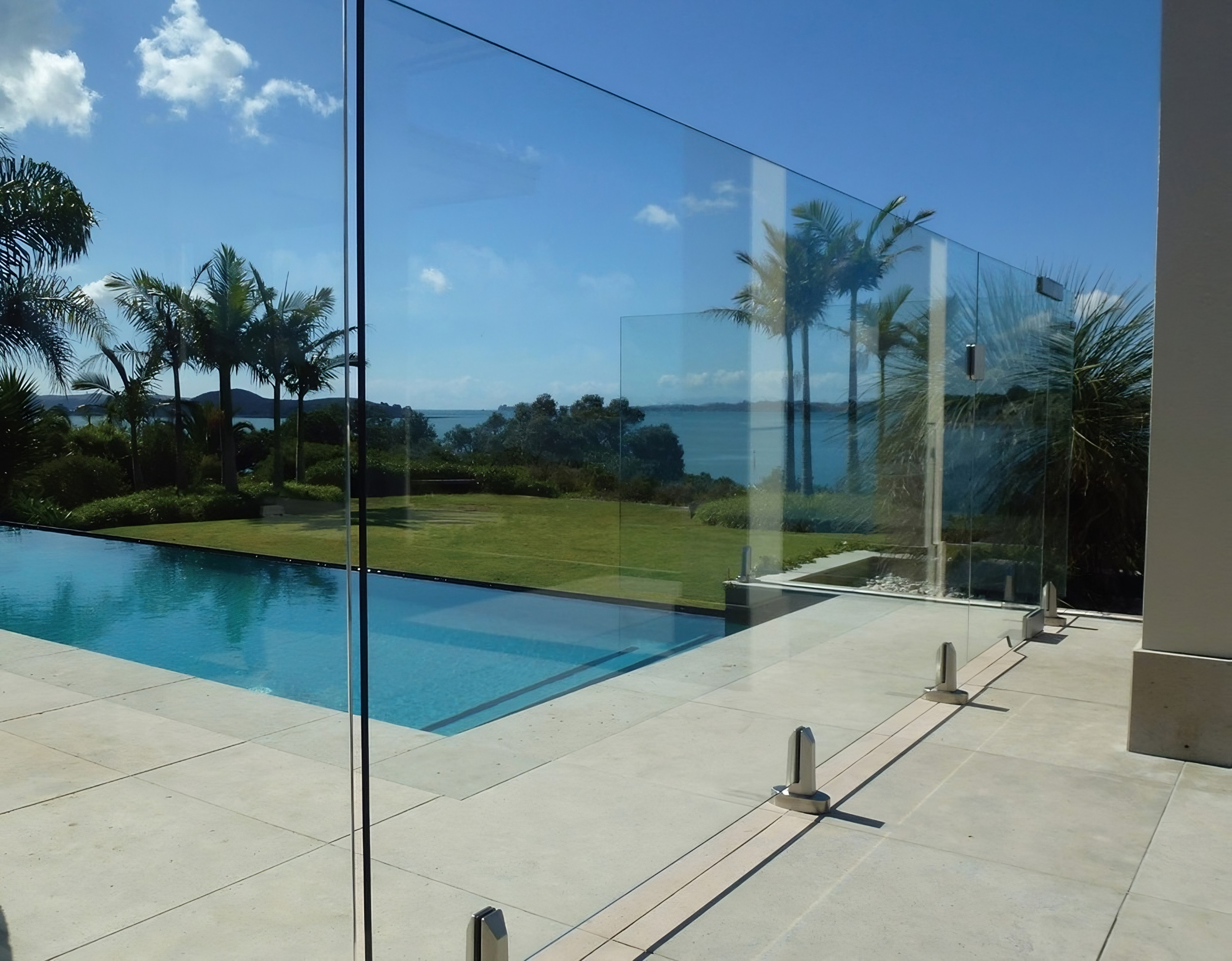 Glass balustrade overlooking swimming pool and ocean view