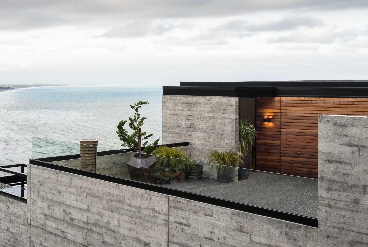 Stone building featuring an open rooftop deck with sweeping ocean views