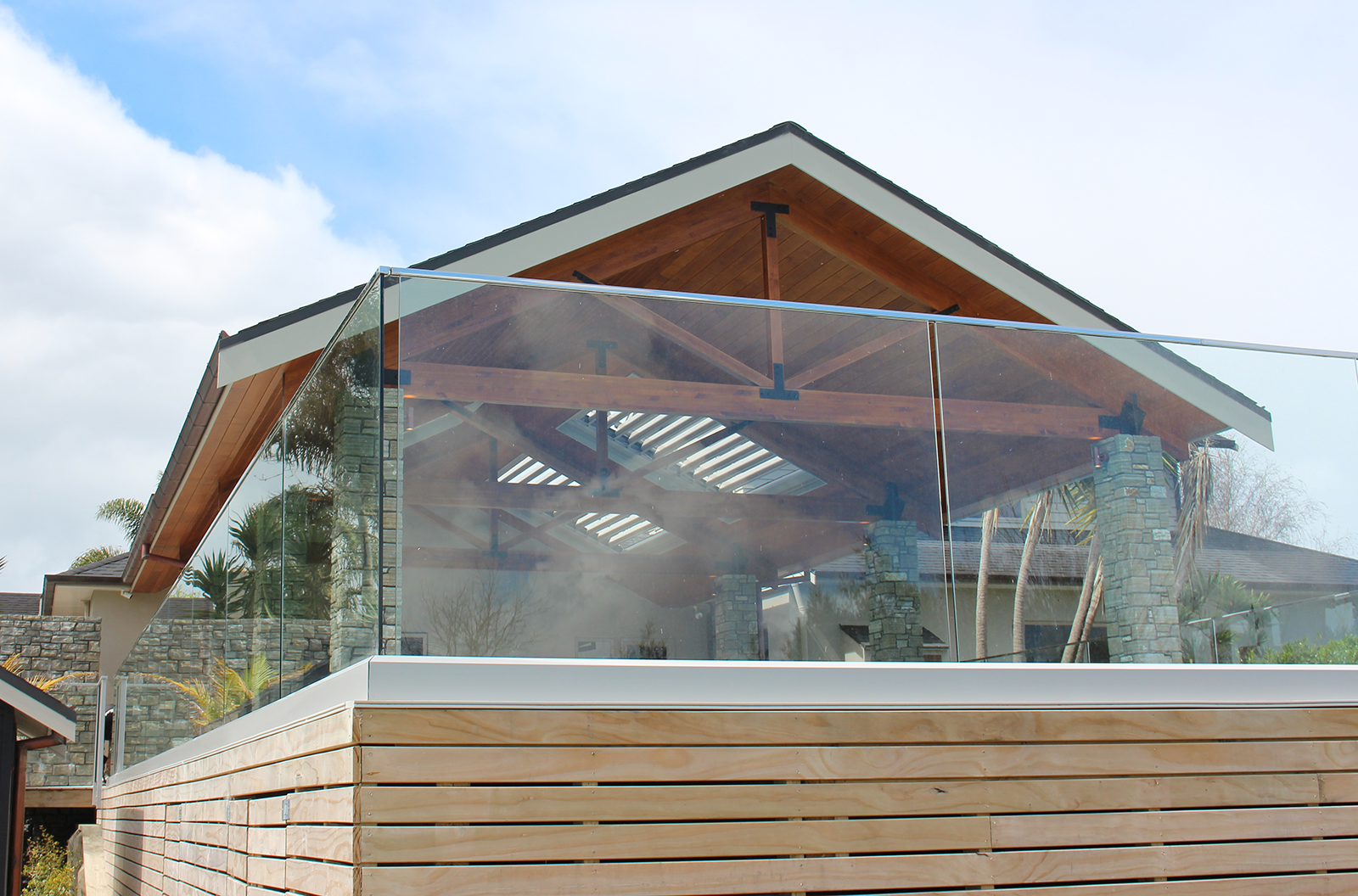 Modern house with a glass balustrade under a clear blue sky