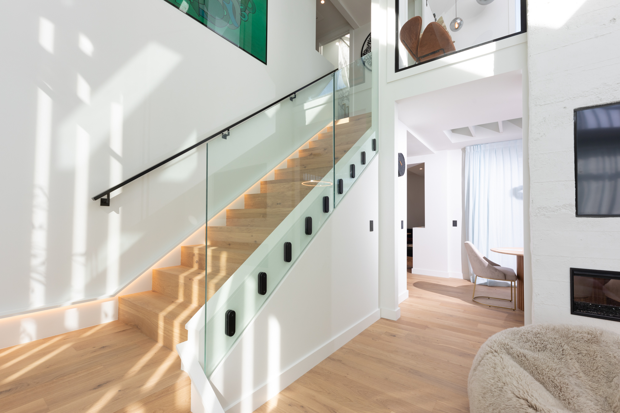 white interior house with a point fix glass balustrade system