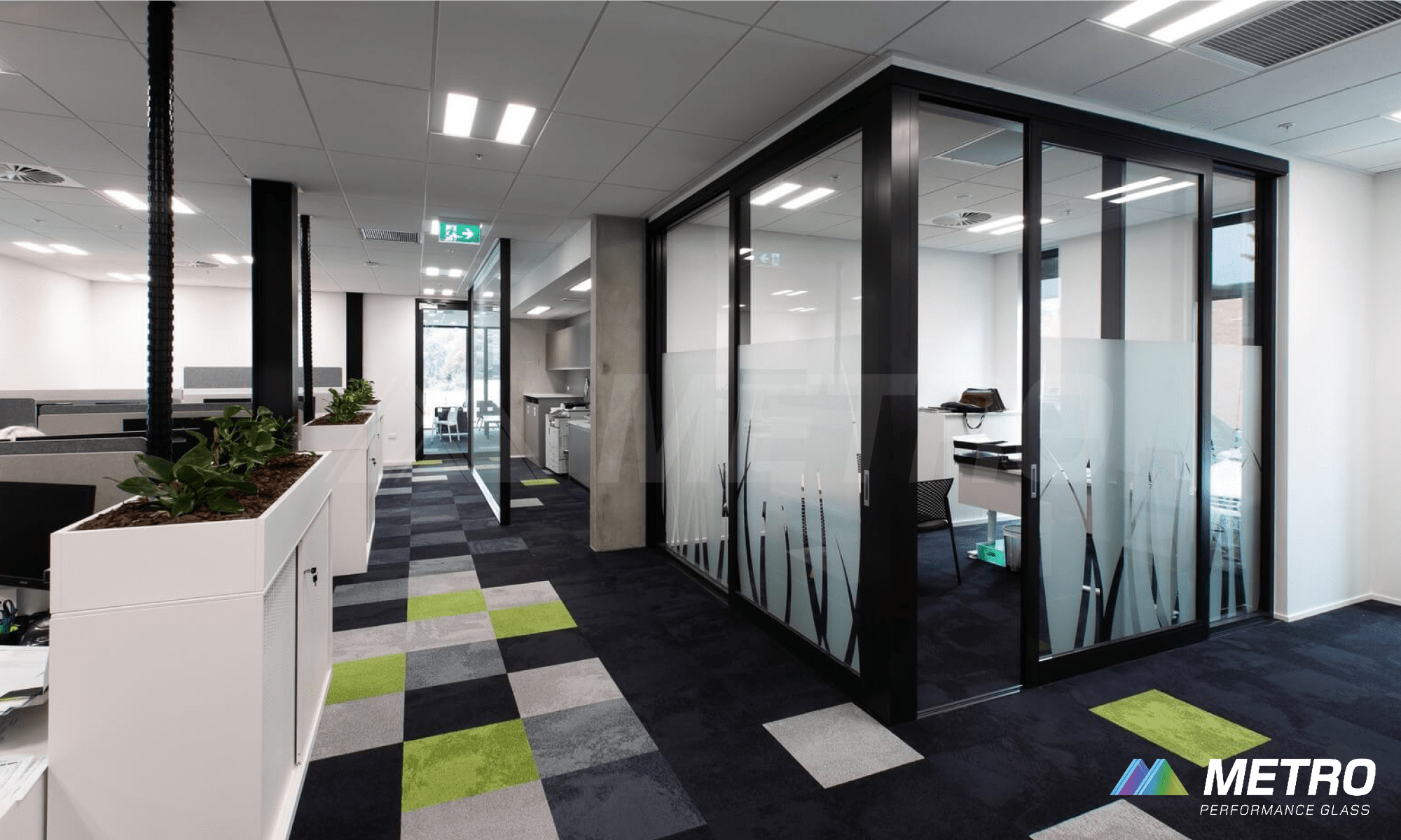 Commercial office space with frosted glass walls and patterned flooring