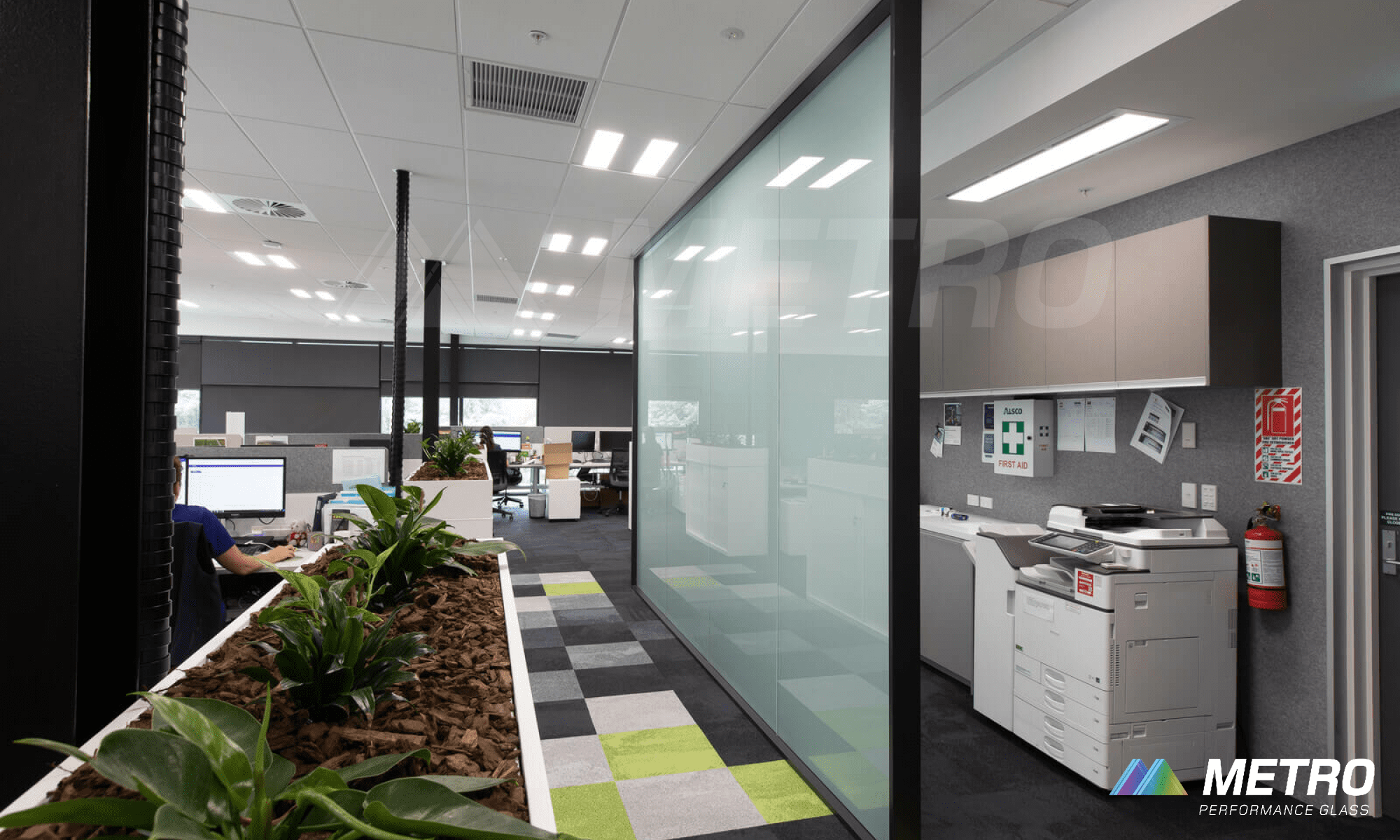 Commercial office space with frosted glass partition and patterned flooring