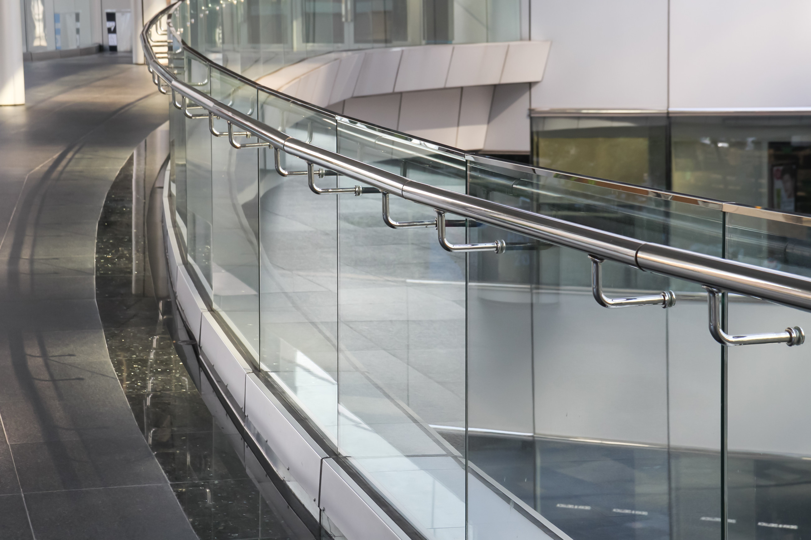 Glass safety railing for commercial spaces, providing both style and security.