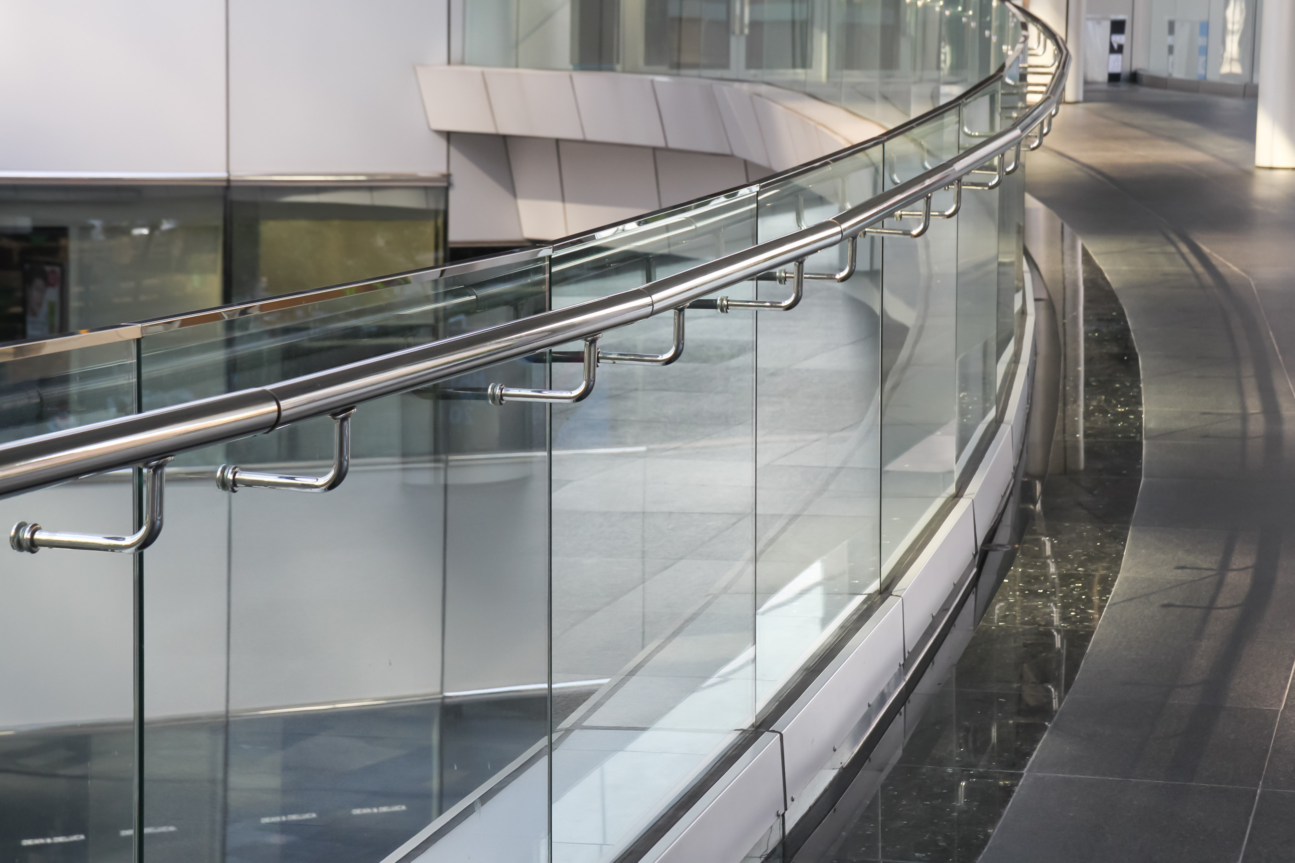 Glass safety railing for commercial spaces, providing both style and security.
