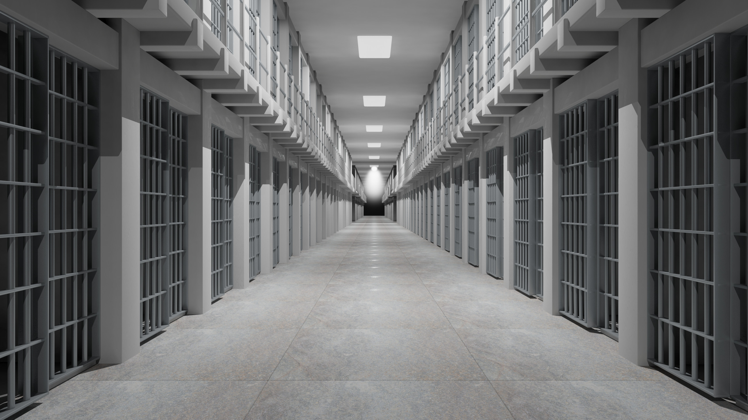 Interior of a prison corridor with visible cell bars on the sides