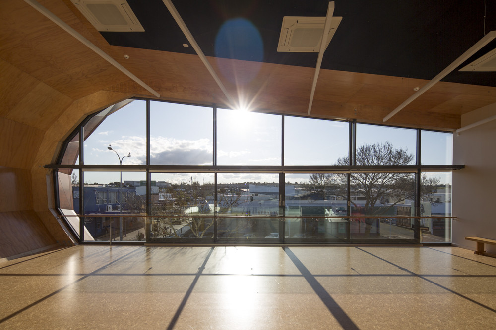 View from inside of building with a curved shape and big glass windows