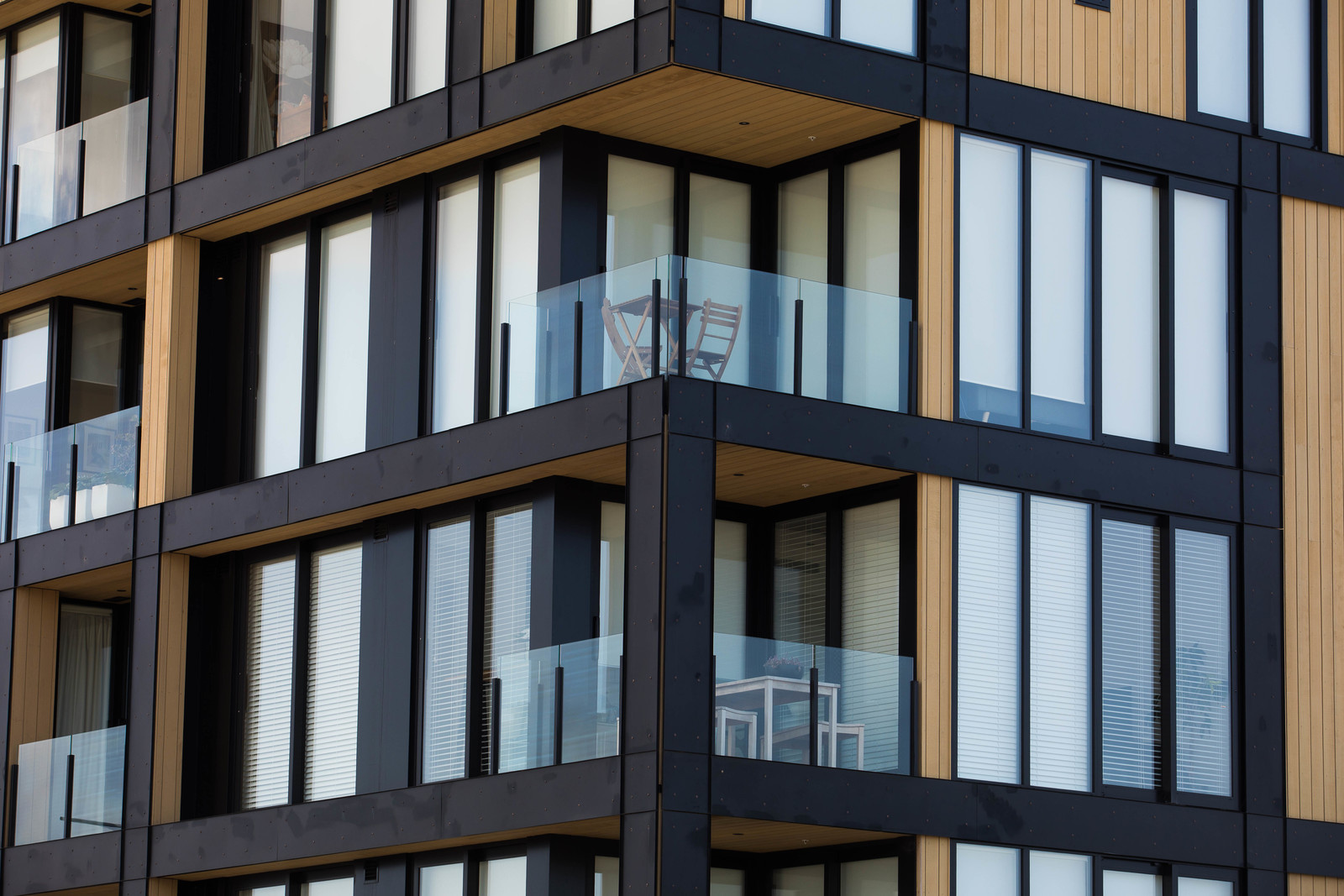 An urban apartment complex with plenty of glass windows and balustrade