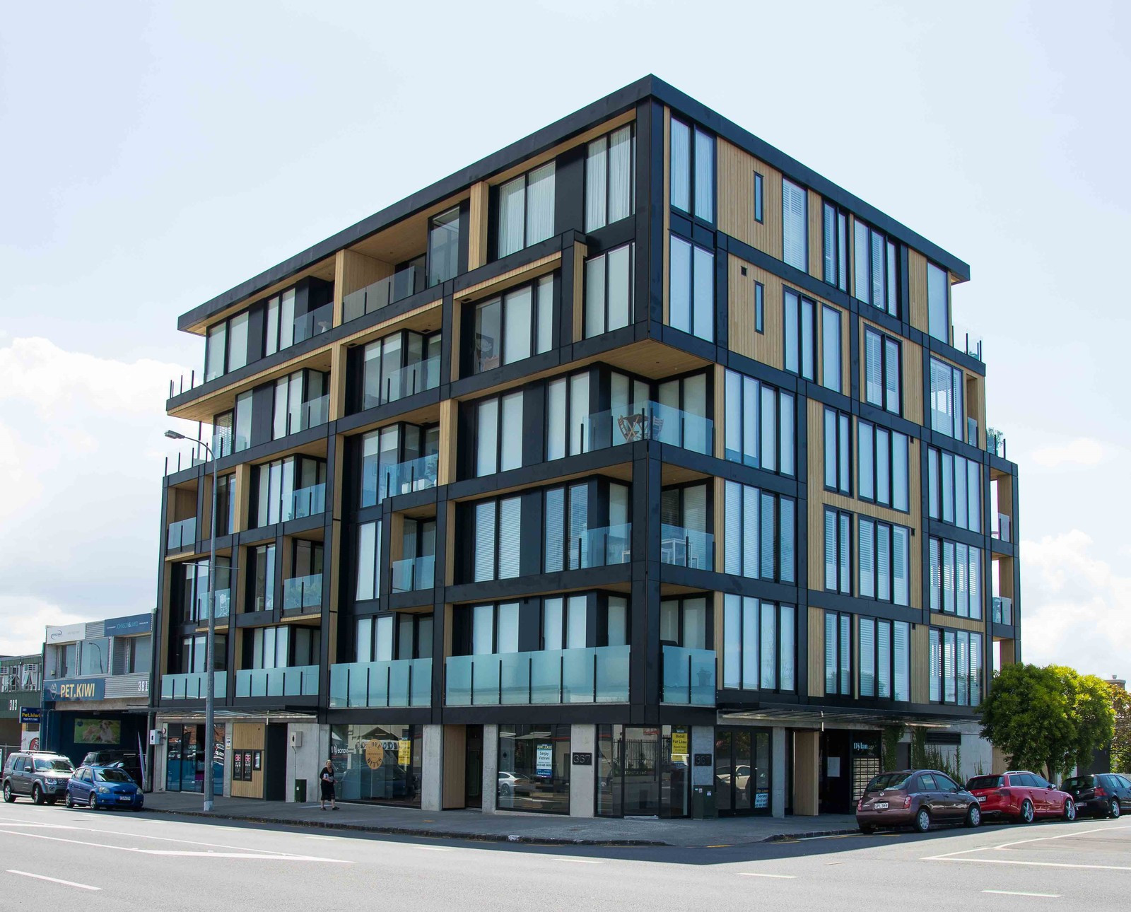 A modern apartment building with glass windows and glass balustrade