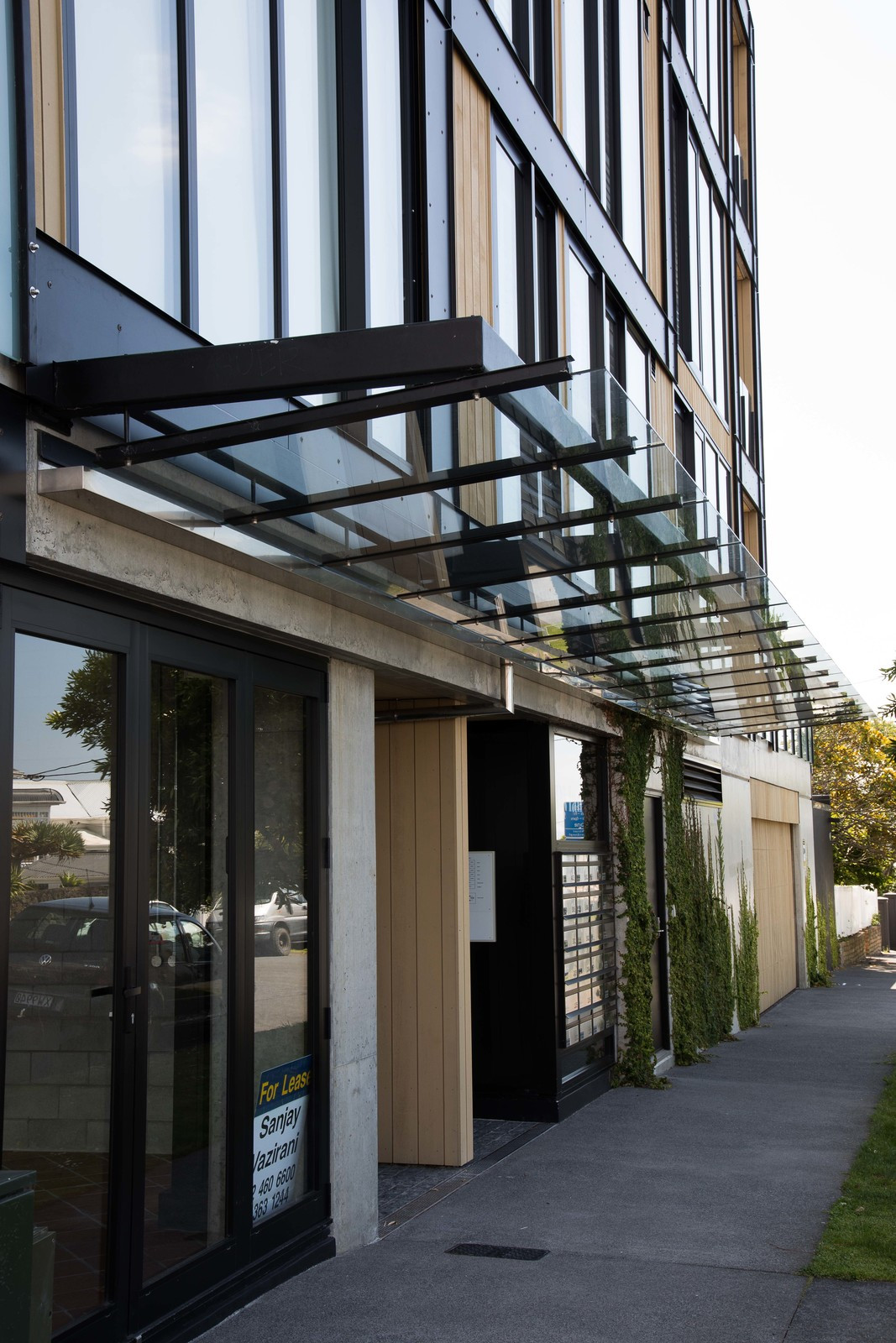 A stylish apartment building showcasing glass windows and balustrade