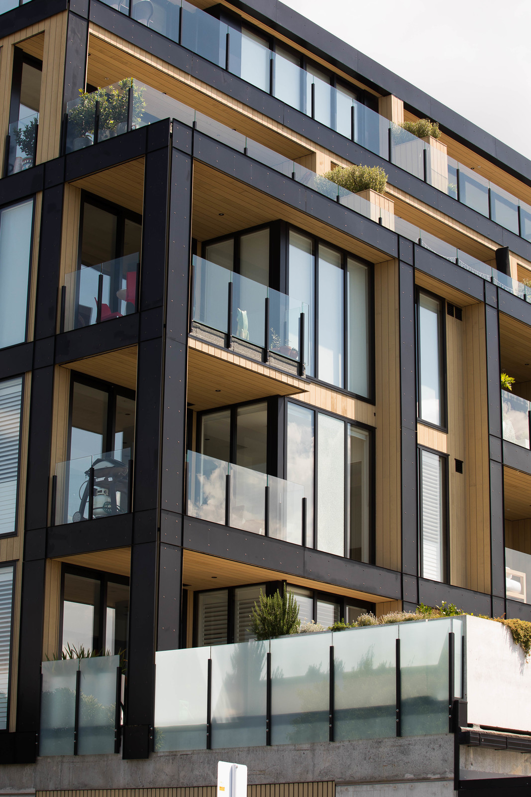 Modern building featuring reflective glass windows and sleek glass balustrades