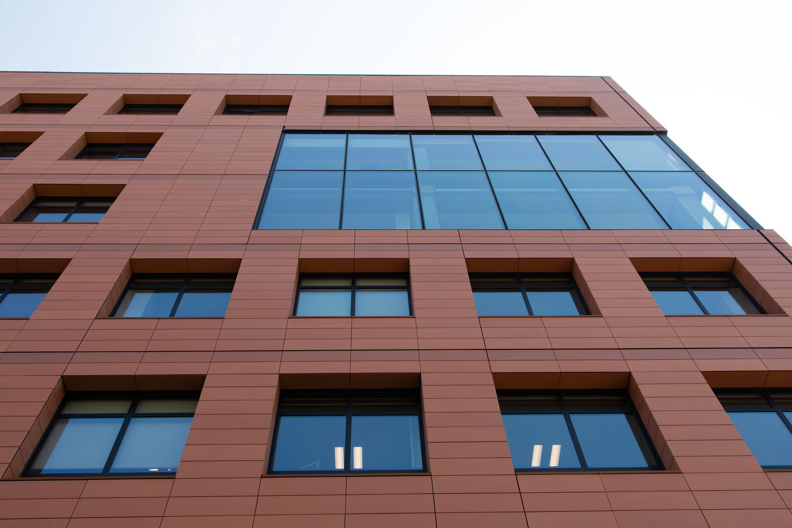 Innovative design of a building with glass windows and terracotta tiles