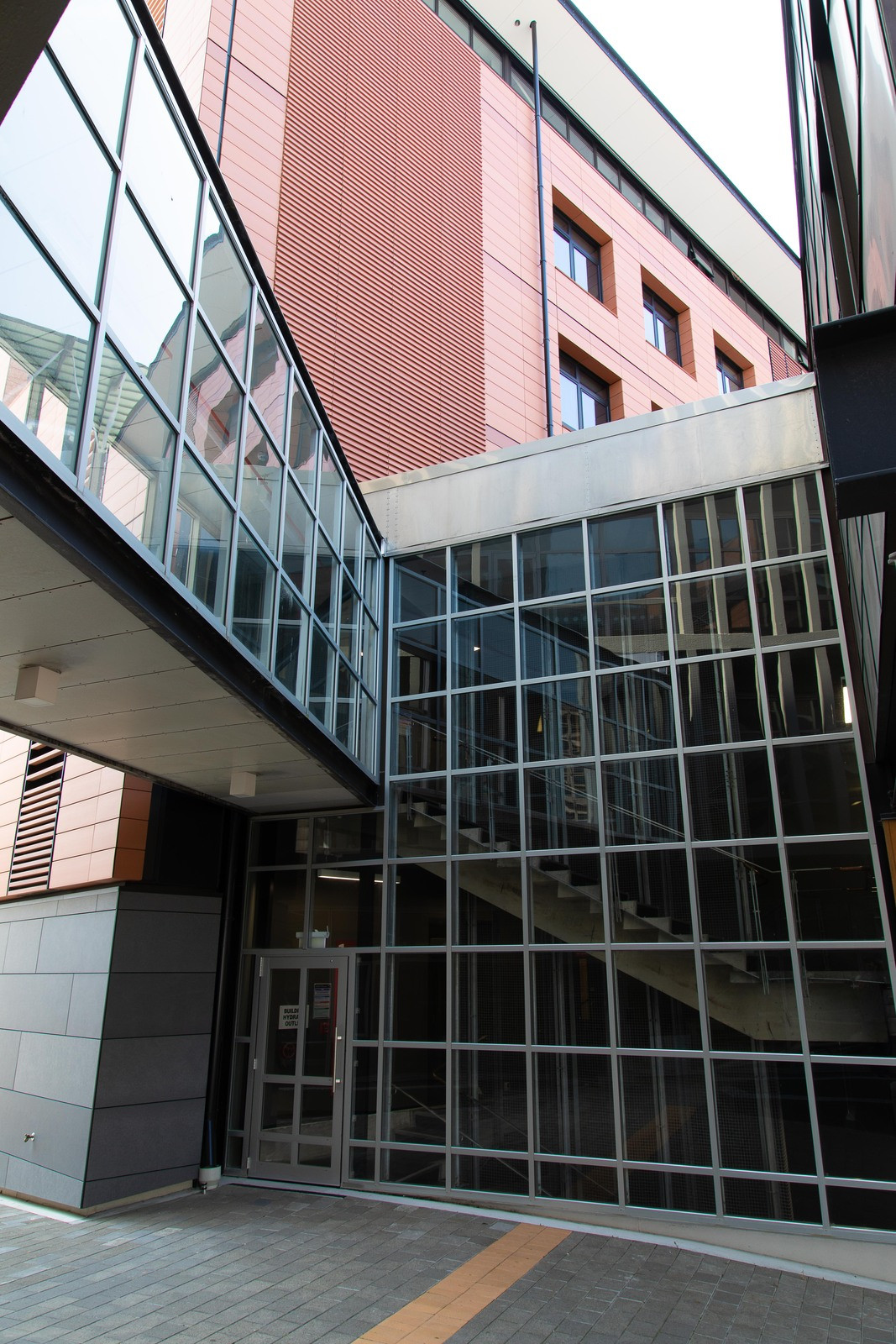 Contemporary red brick building with prominent glass windows