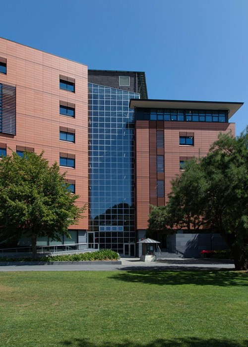 Angular building featuring a combination of red brick and glass window façades