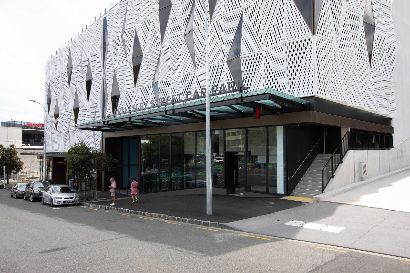 Modern structure with a white perforated metal screen exterior