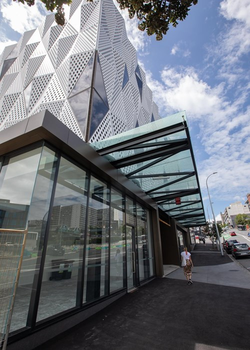 Artistic white facade with integrated glass windows on a modern building