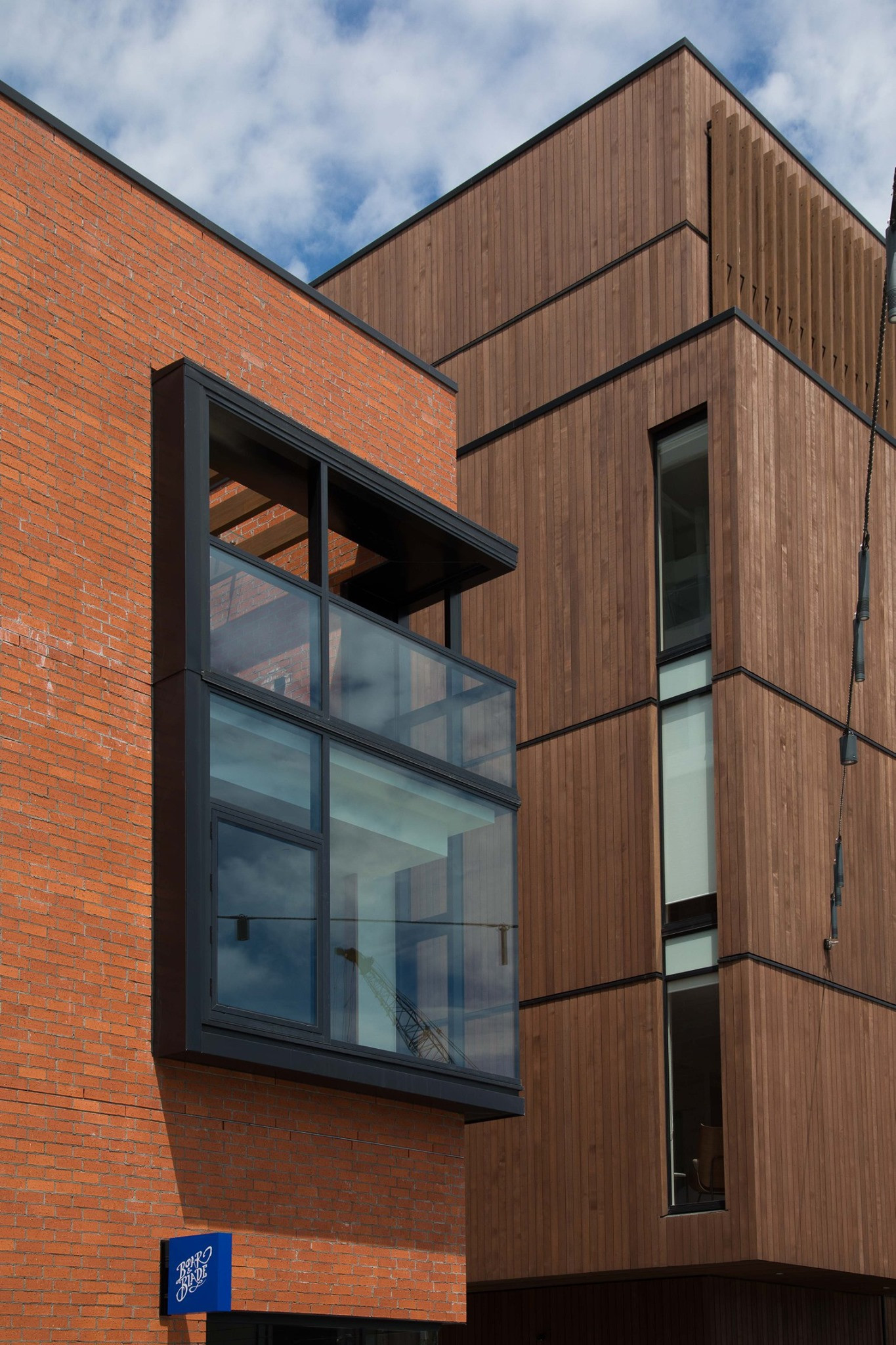 Stylish urban apartments with red brick walls and sleek black-framed windows