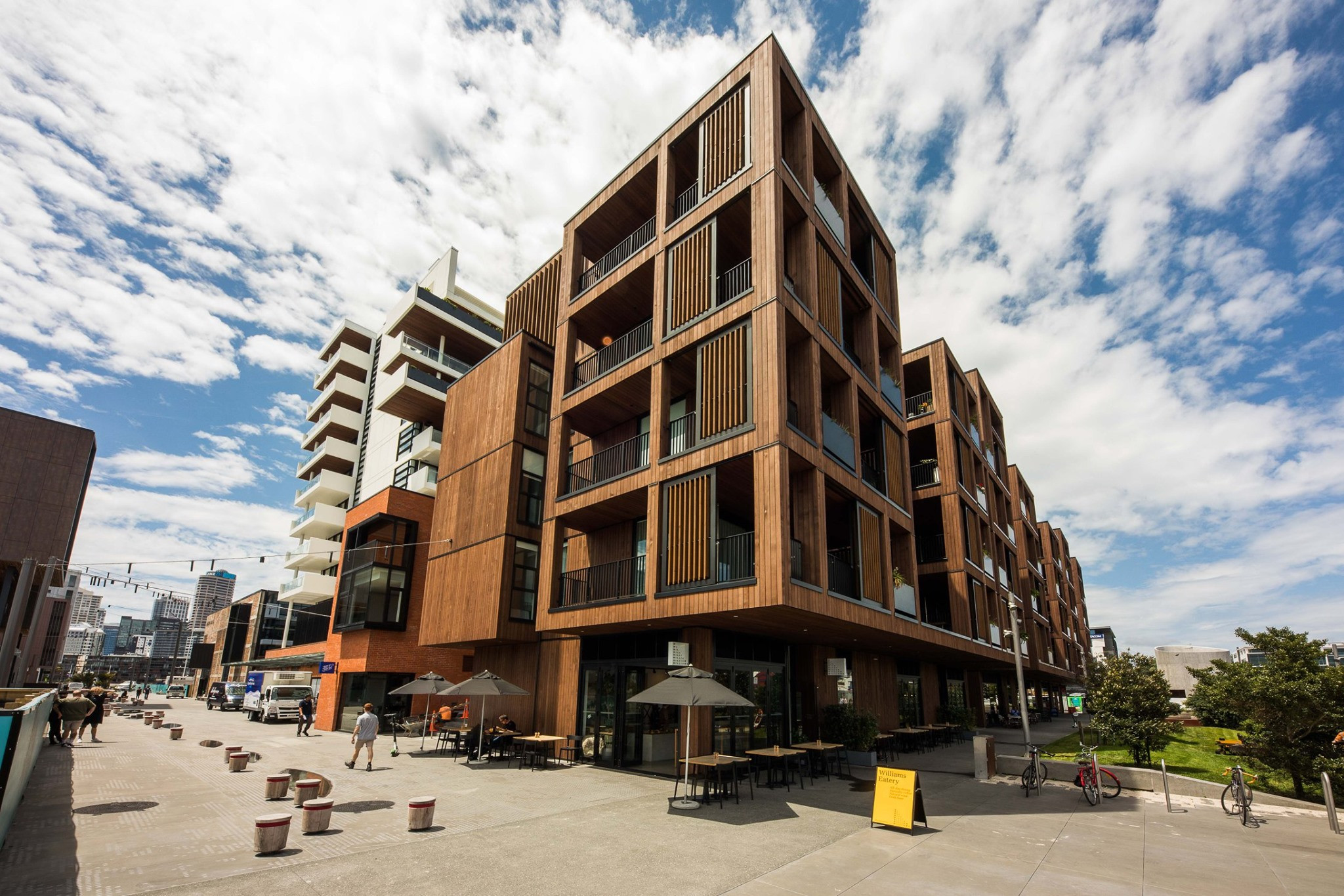 Contemporary urban housing with wooden facade and glass safety railings