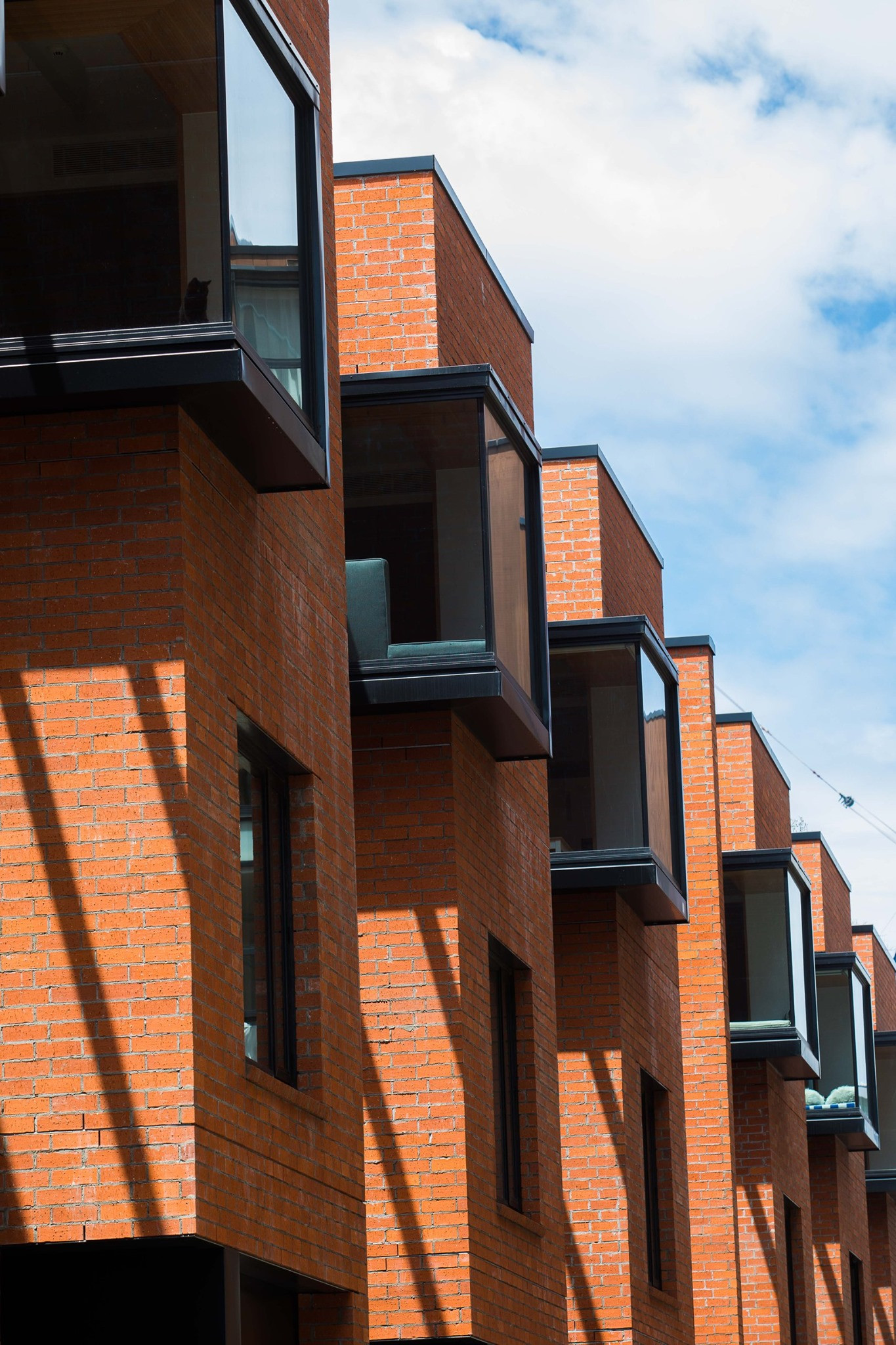 Chic urban living spaces with red bricks and black framed windows