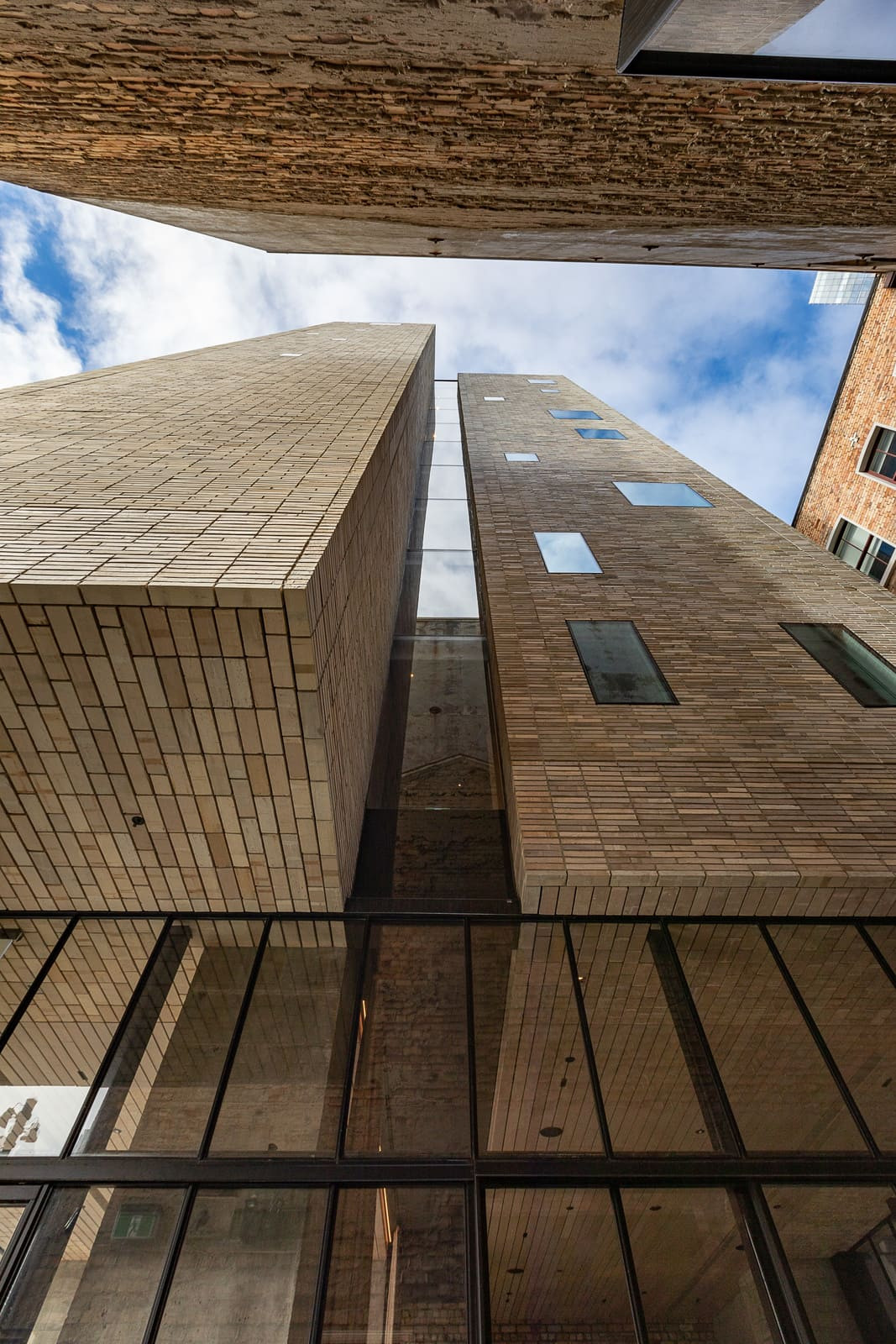 View from ground up of Britomart hotel, high windows and brick exterior