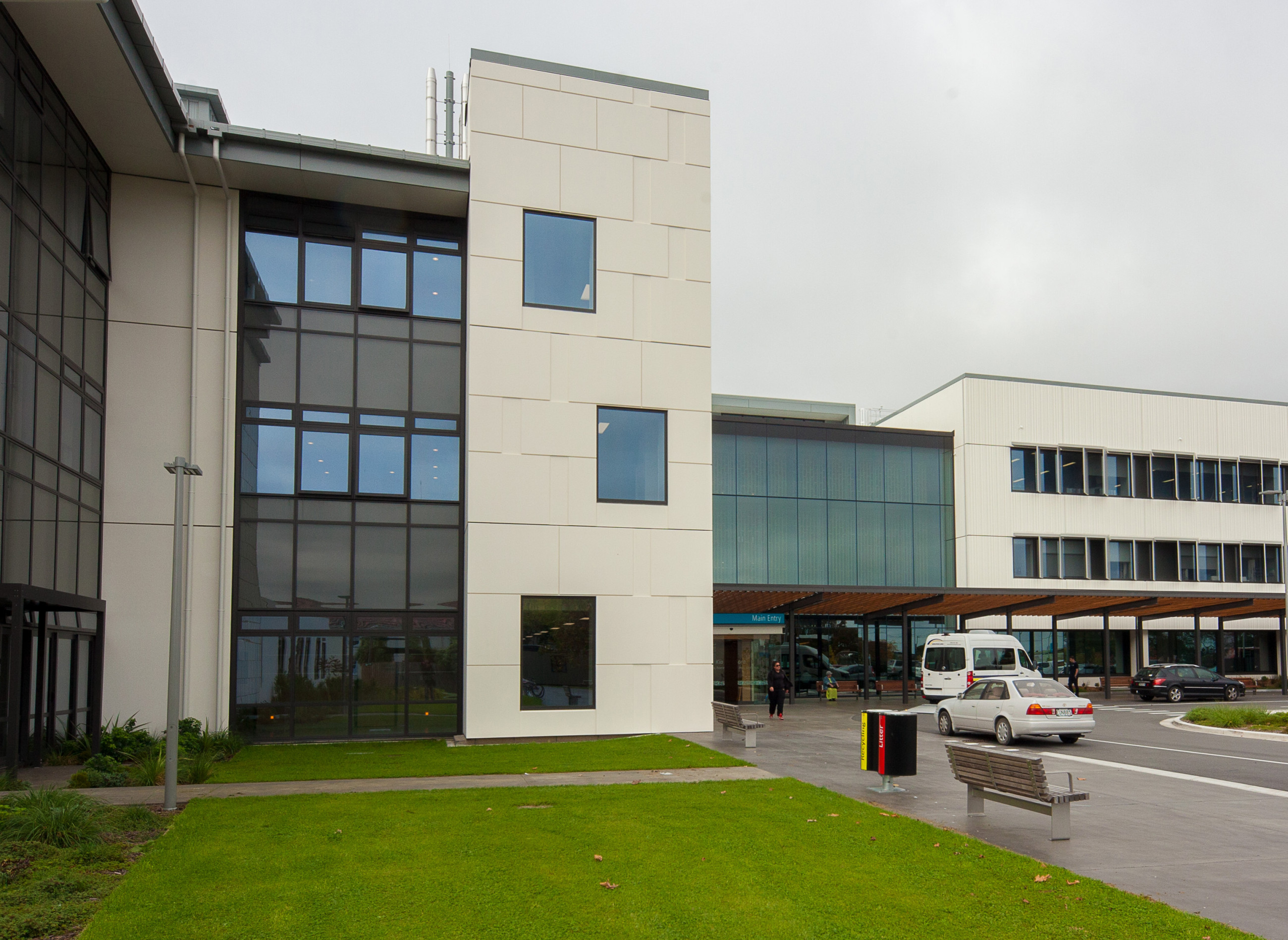 Glass walled Burwood Hospital building with bench and door