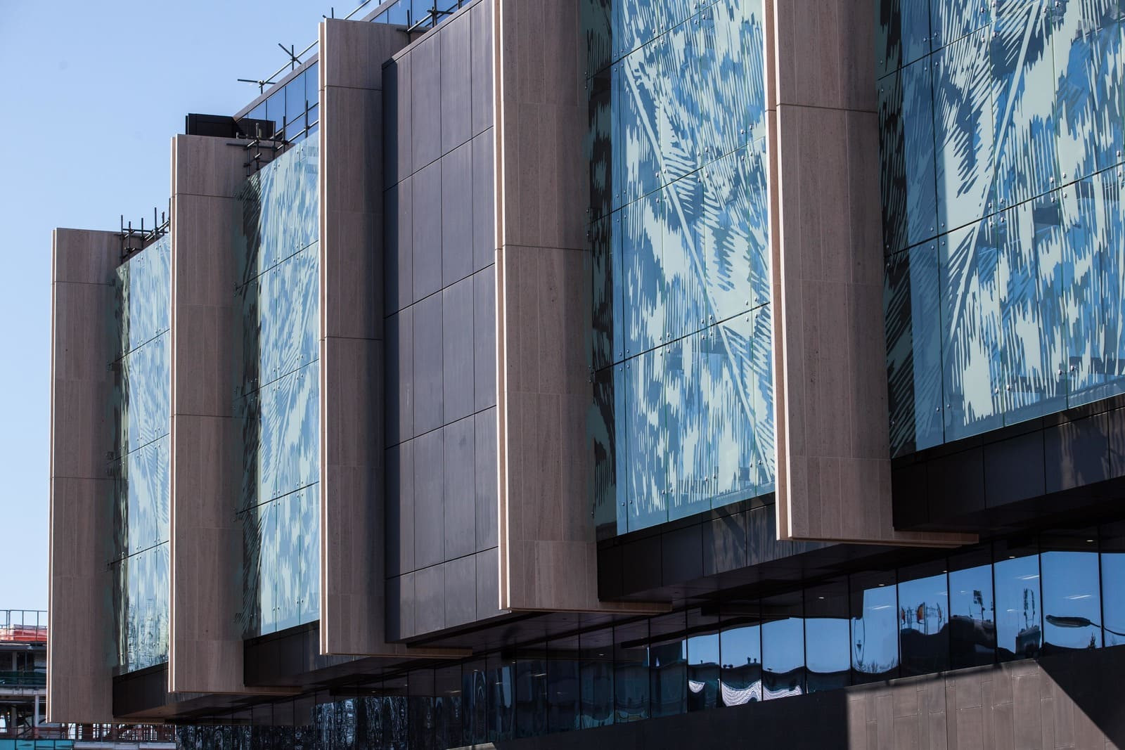 A modern glass building with a huge window, Christchurch Justice Precinct, showcasing a sleek and sophisticated design