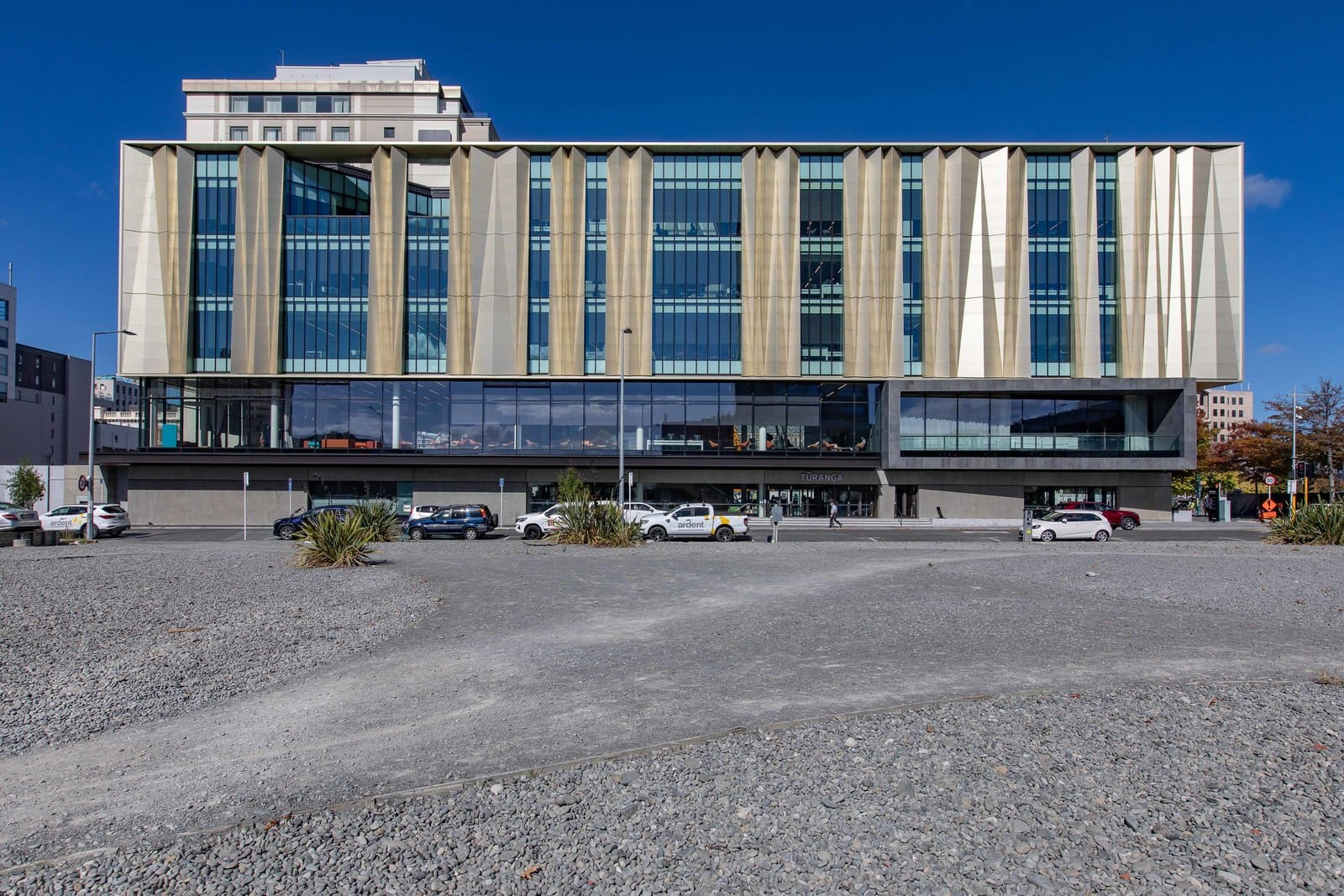 A modern library with large windows and a stylish patterned facade