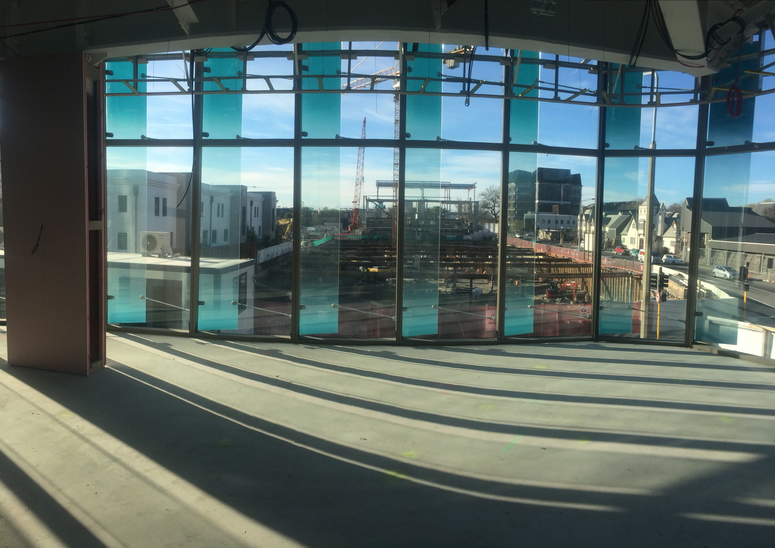 A stunning view from a building with glass windows, showcasing a beautifully highlighted facade