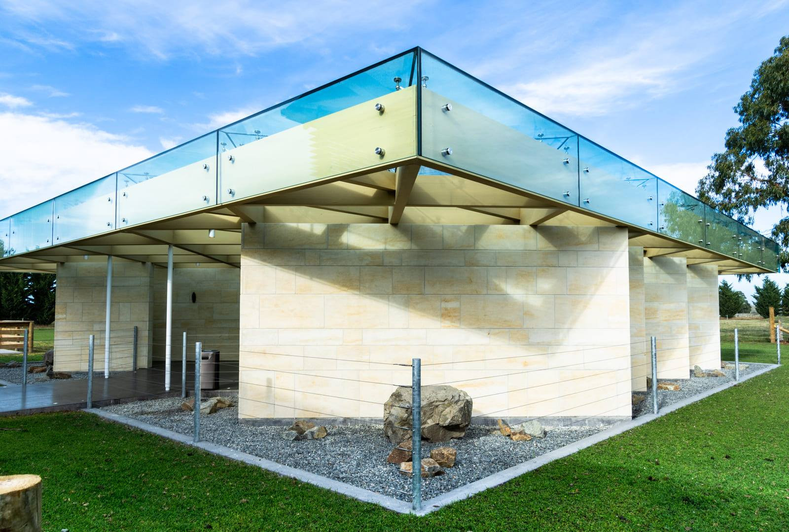 Light brick building with highlighted glass panels