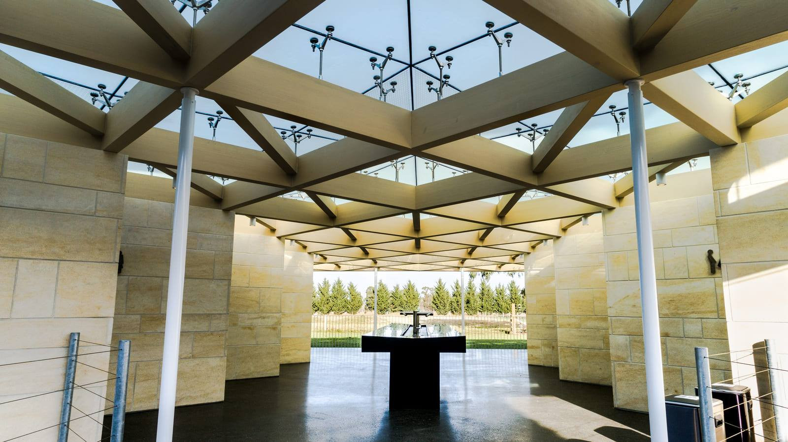 Sky visible through highlighted triangle patterned glass ceiling