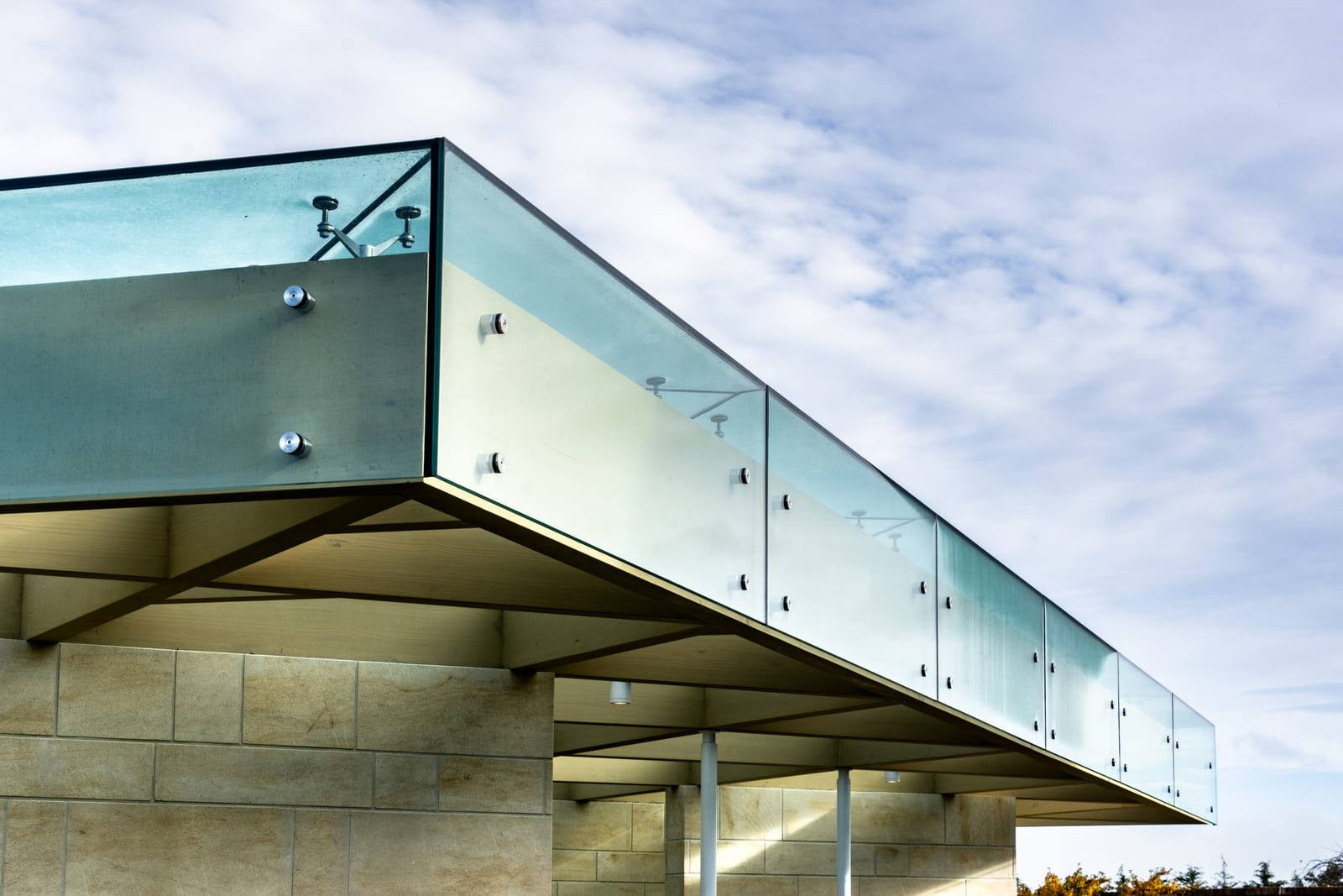 Glass panels stand out on a light brick building