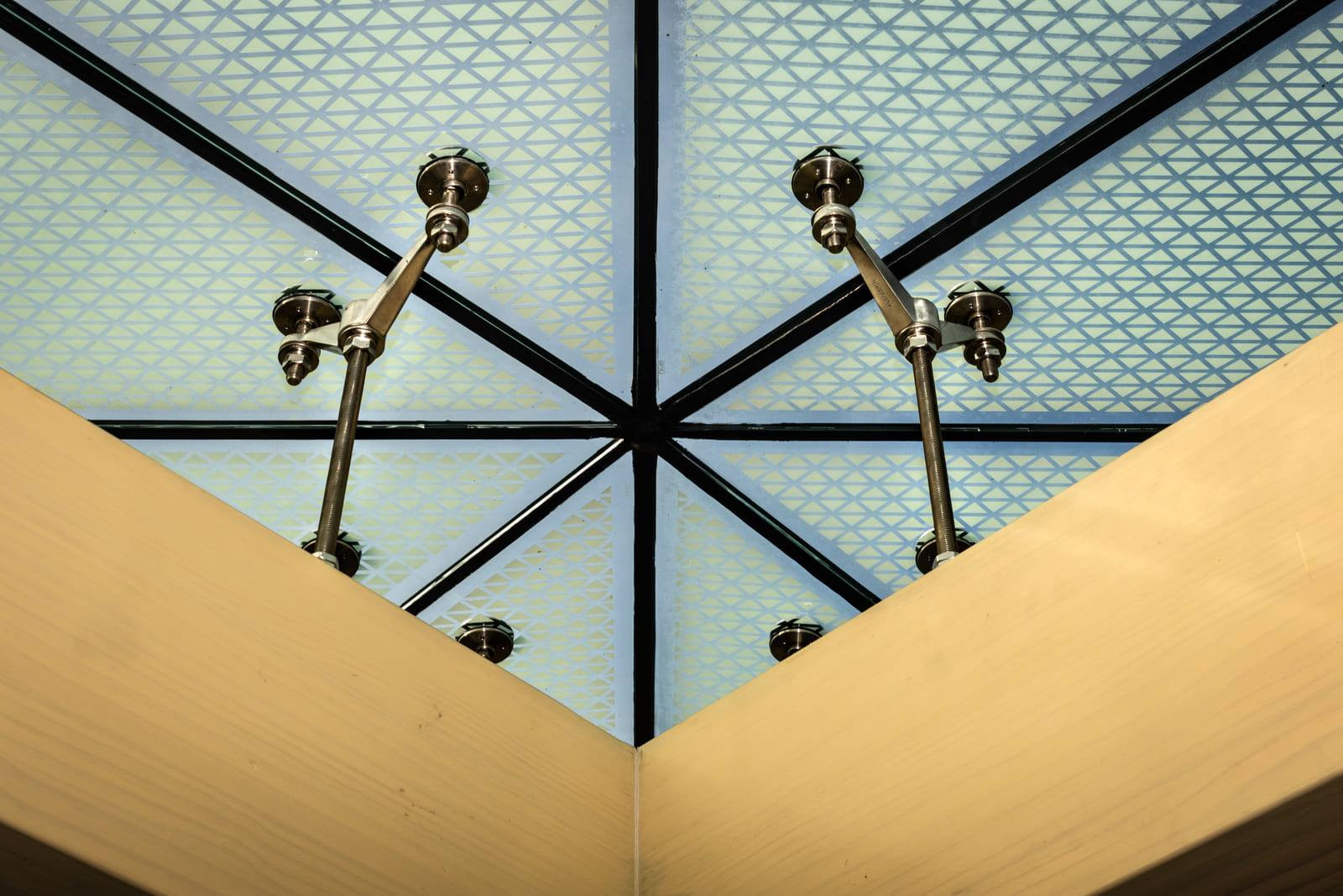 Clear sky seen through patterned glass roof panels