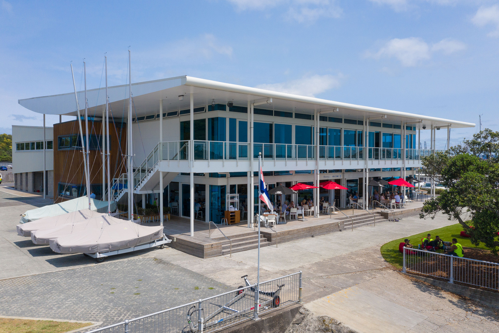 Glass windows and wooden timber exterior on building, surrounded by boats