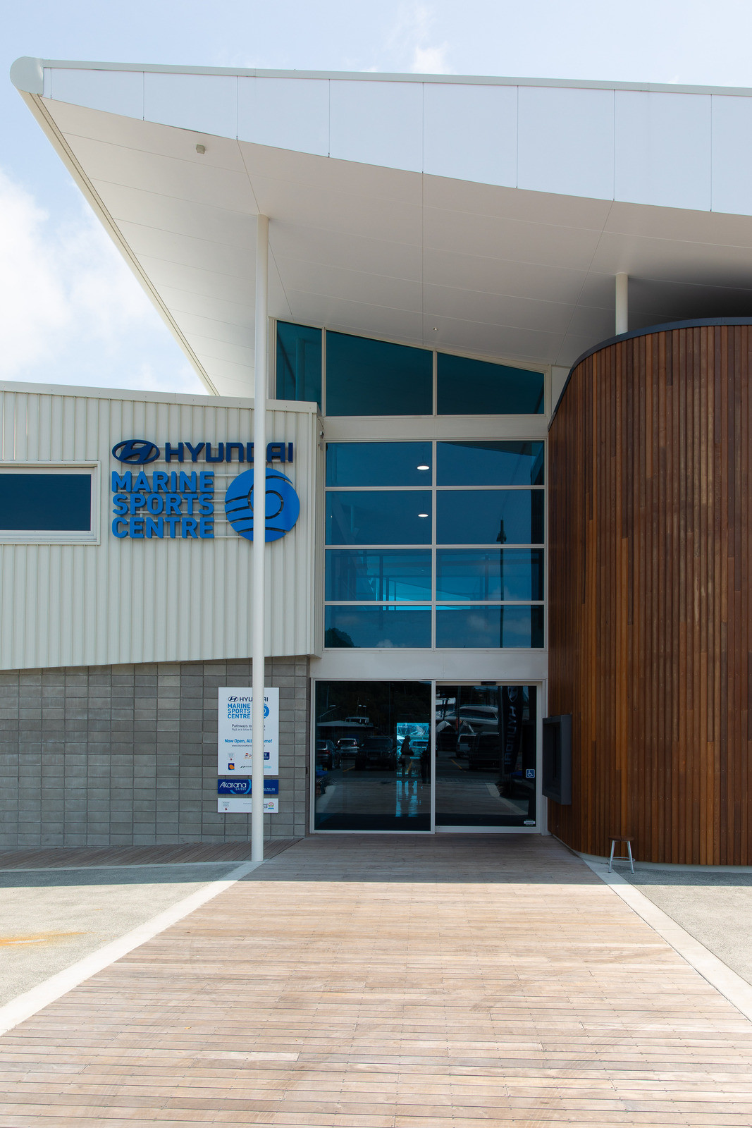 White building with tinted glass windows and wooden timber exterior