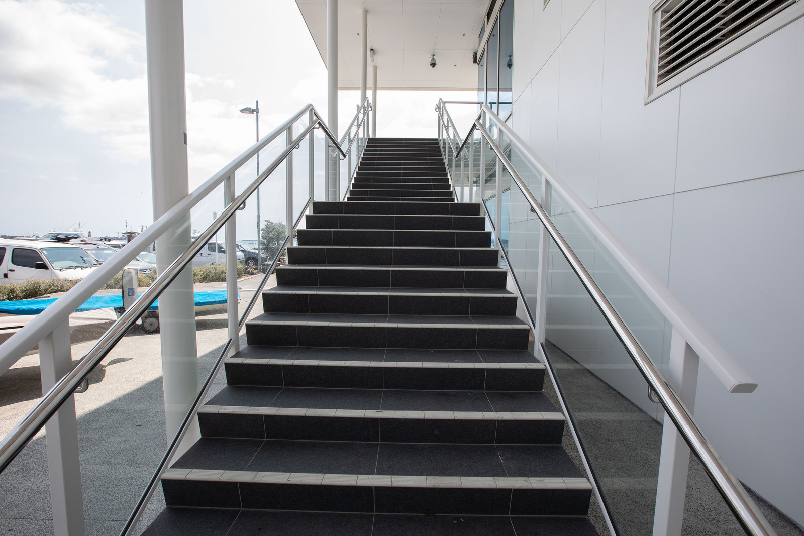 black stairs with glass balustrade railing
