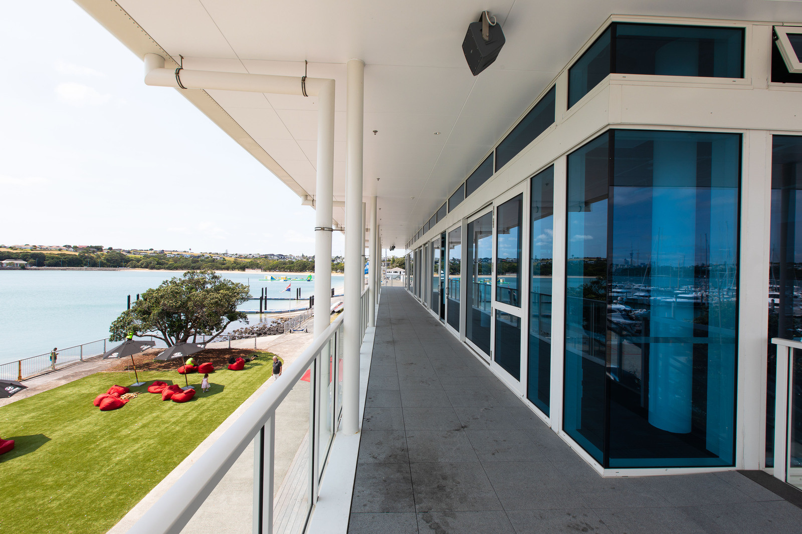 Glass tinted windows on deck with glass balustrade, offering stunning ocean views