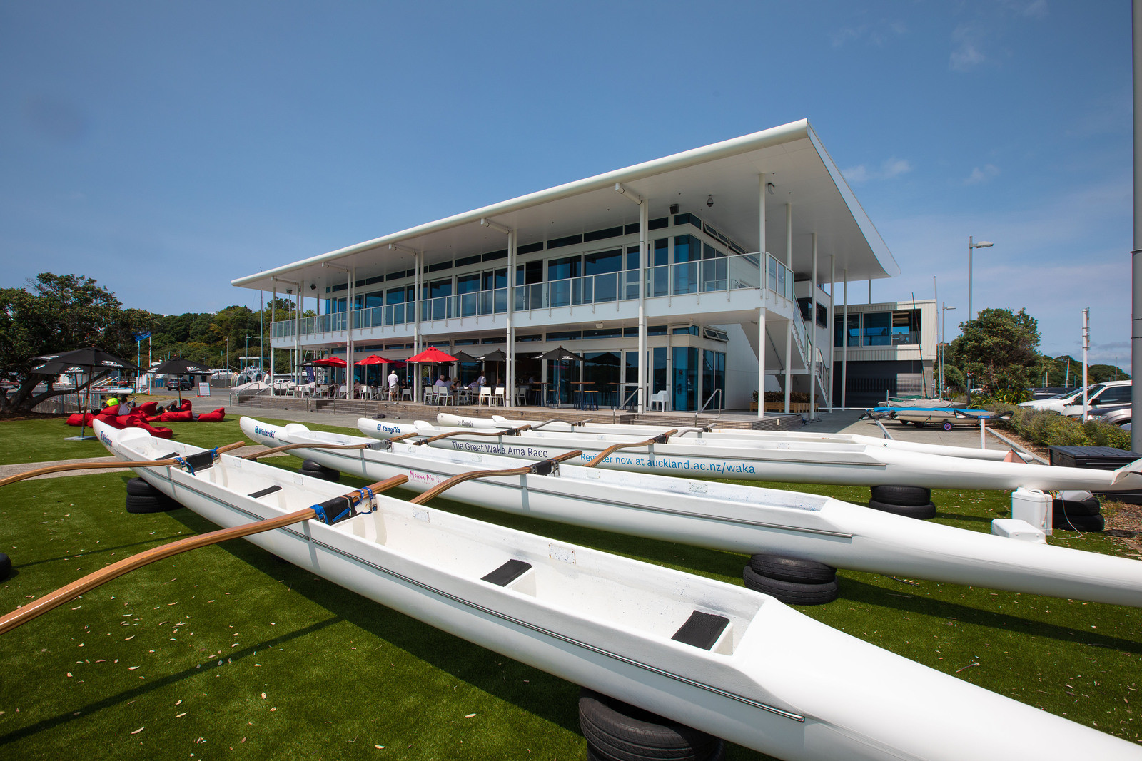 A majestic building with boats in front on a sunny day