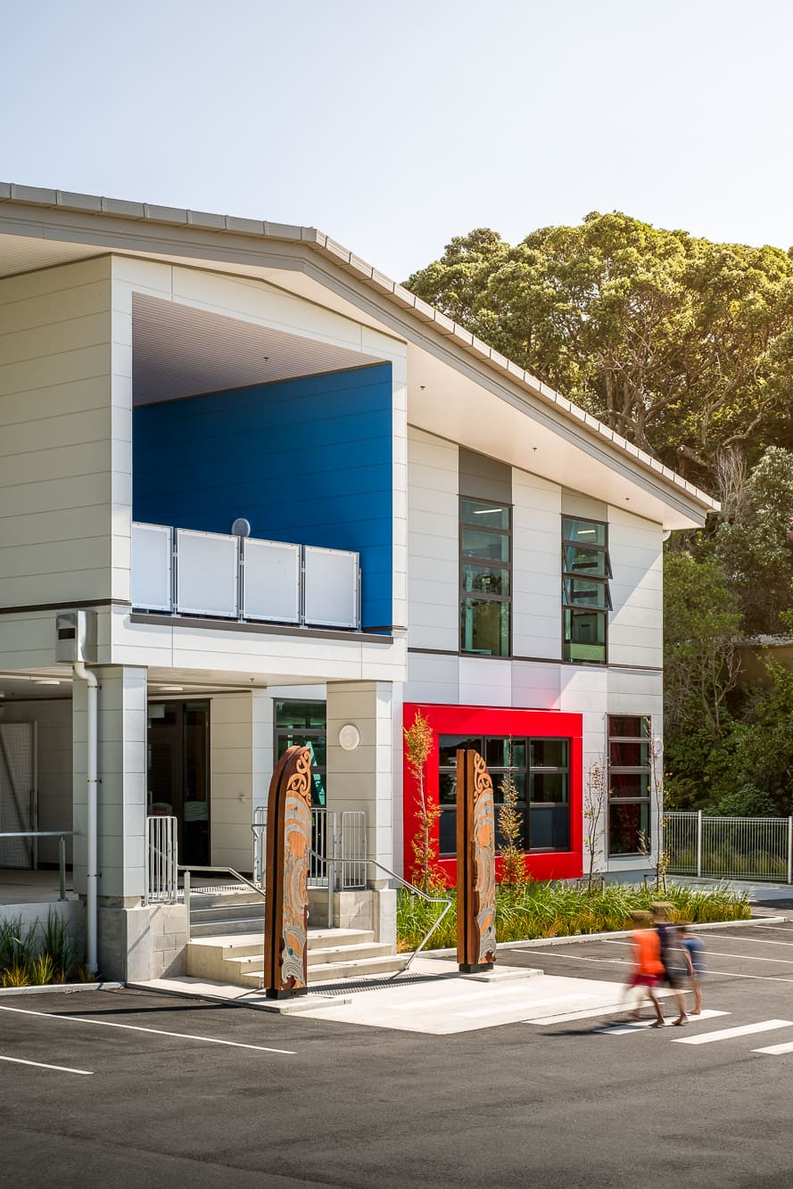 Opope Beach School's colorful building and parking area, with large windows