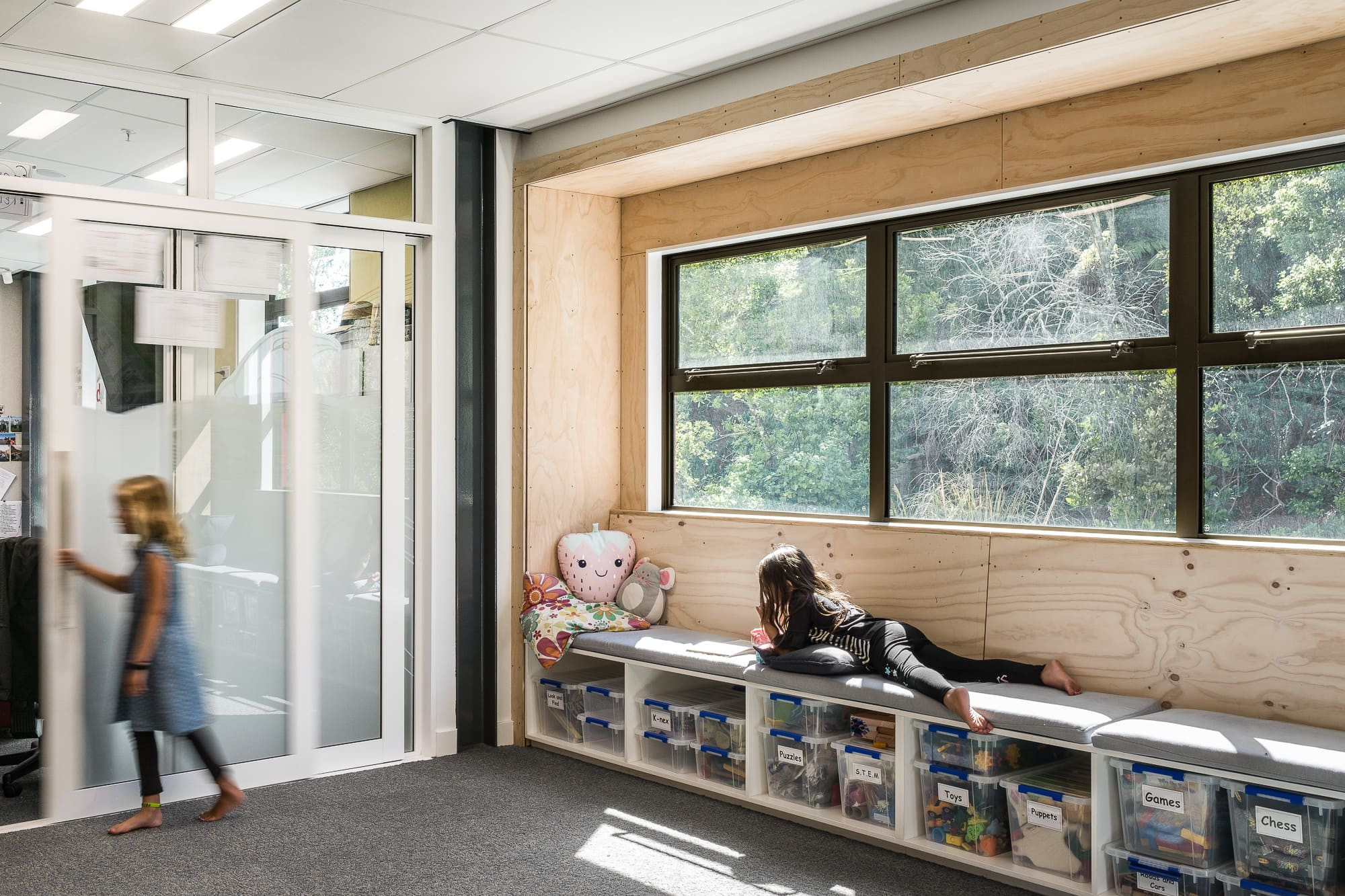 Classroom with glass walls, children having fun