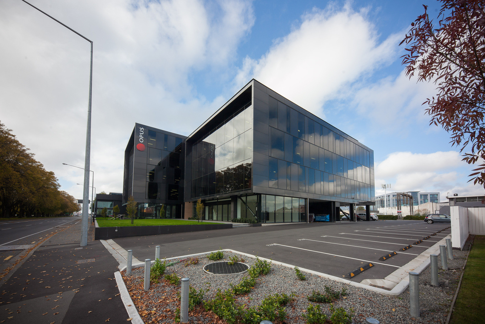 Modern Opus house with dark tinted windows, set against a parking lot