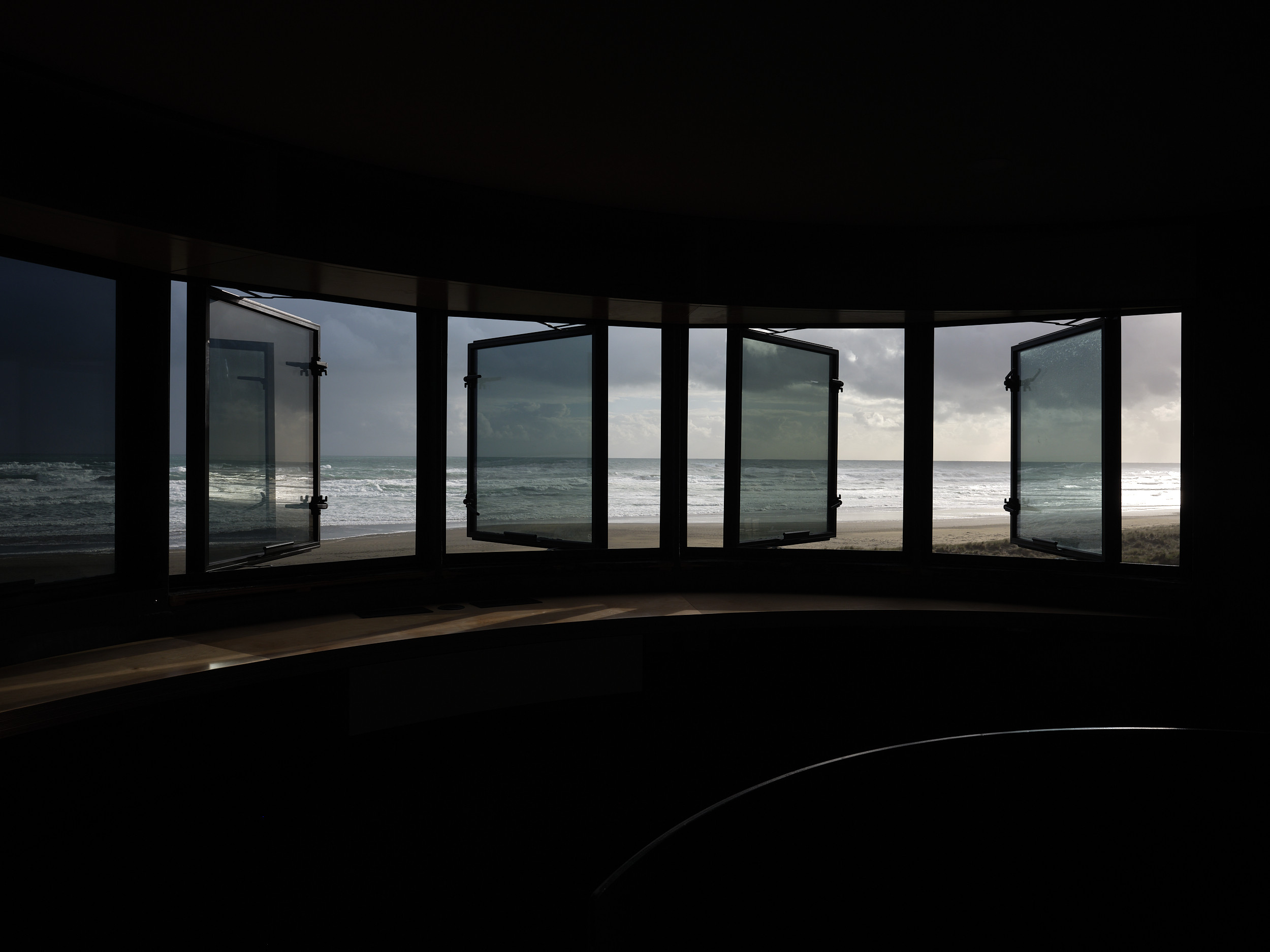 Open tinted windows, overlooking the beach