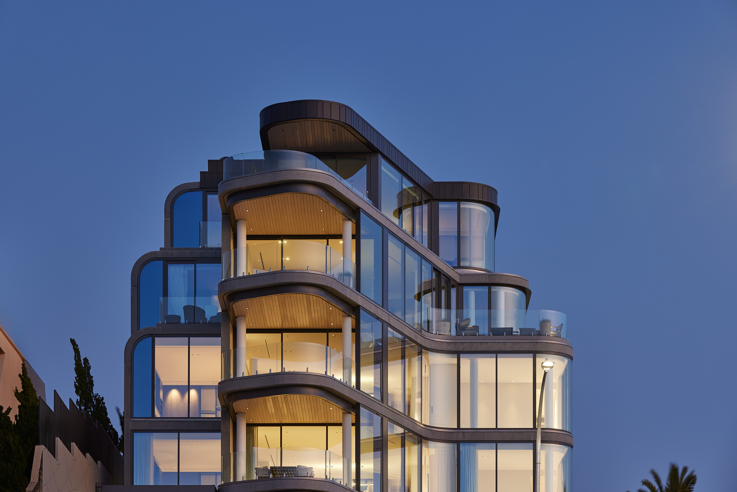 Contemporary home on hillside with glass windows