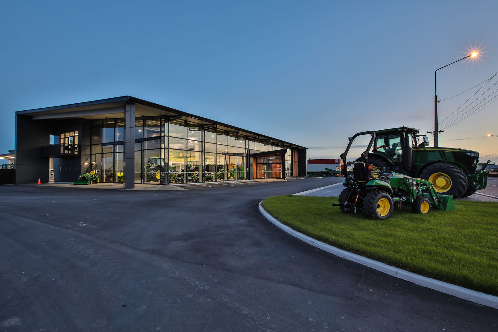 Clear glass windows showing blue sky and tractors  outside